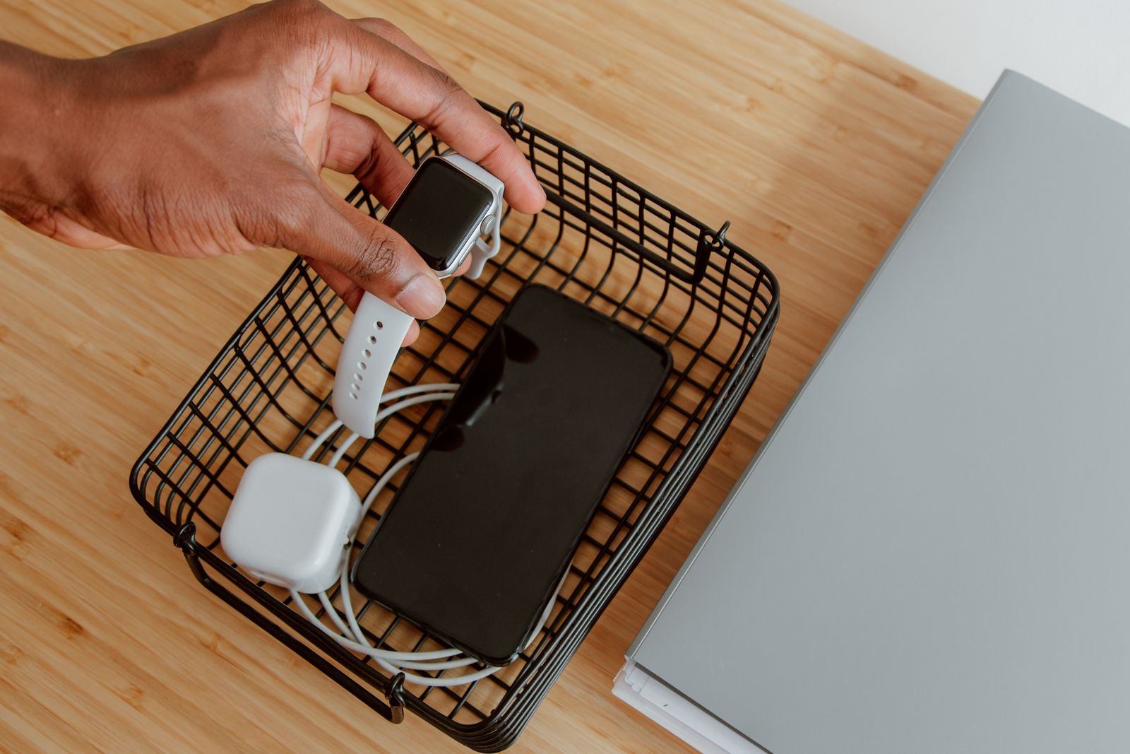 A multi-device stand charging a phone, watch, and earbuds