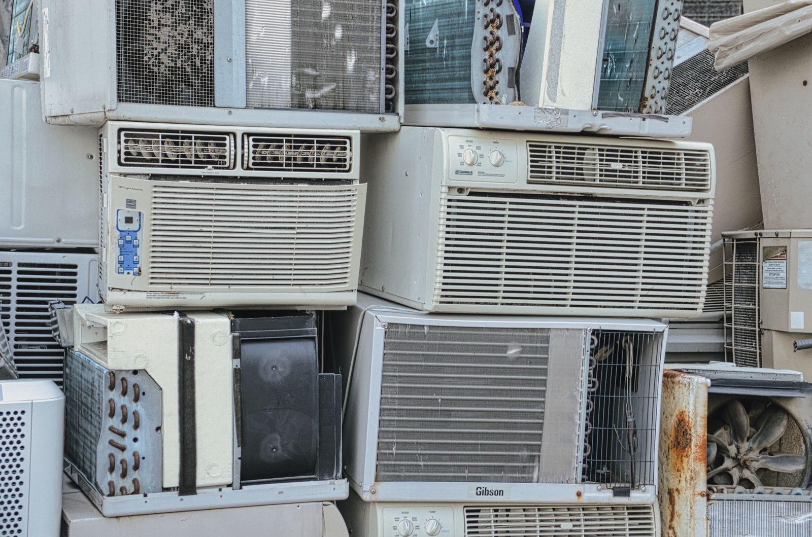 White window-type air conditioner installed in a home window
