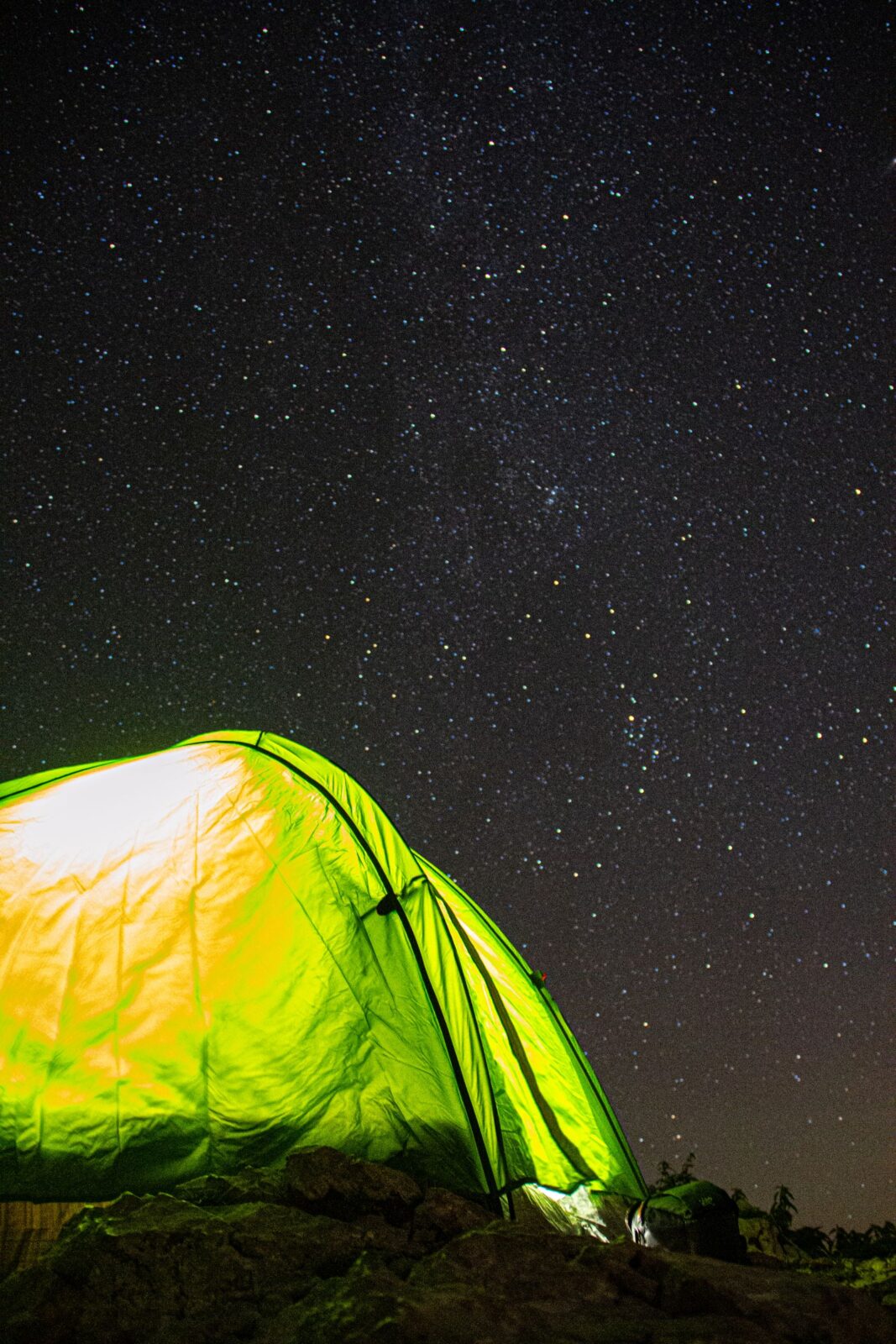 Illuminated camping tent glowing at night at a campsite