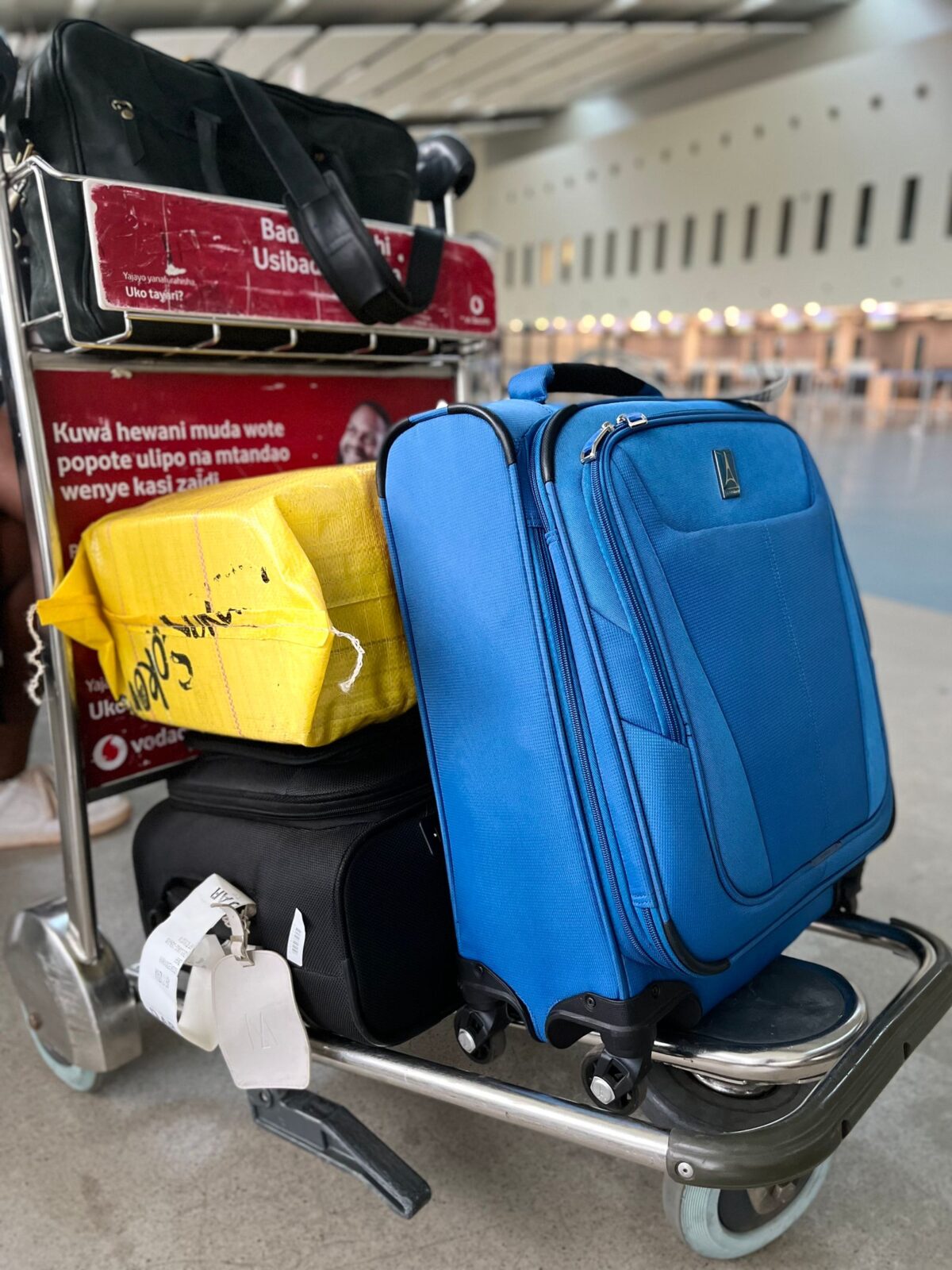 Wheeled rolling suitcase standing in an airport