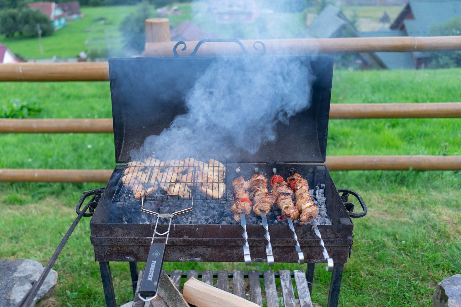 Food cooking on a gas grill in a backyard
