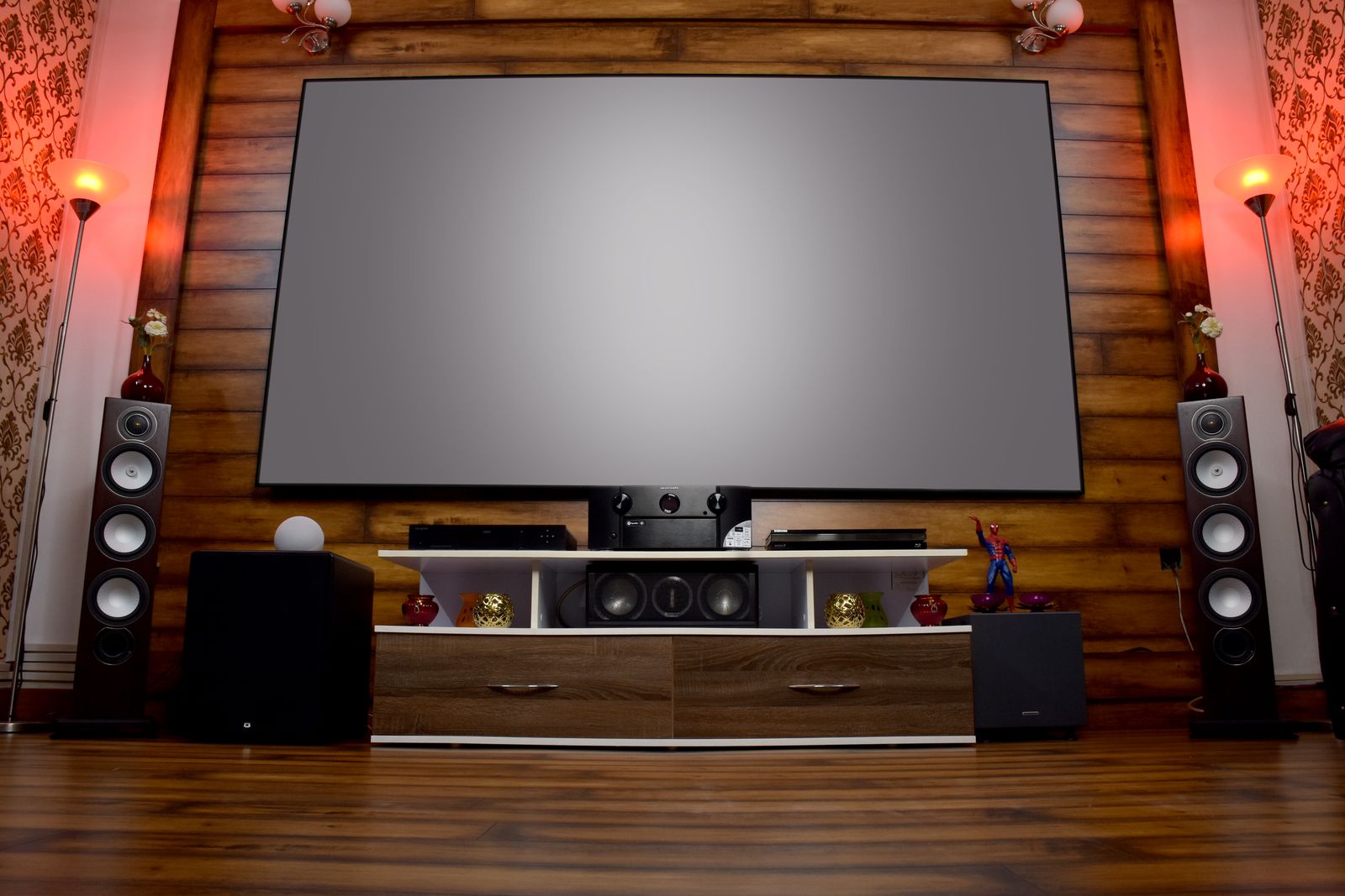 A home theatre setup with a projection screen and audio equipment