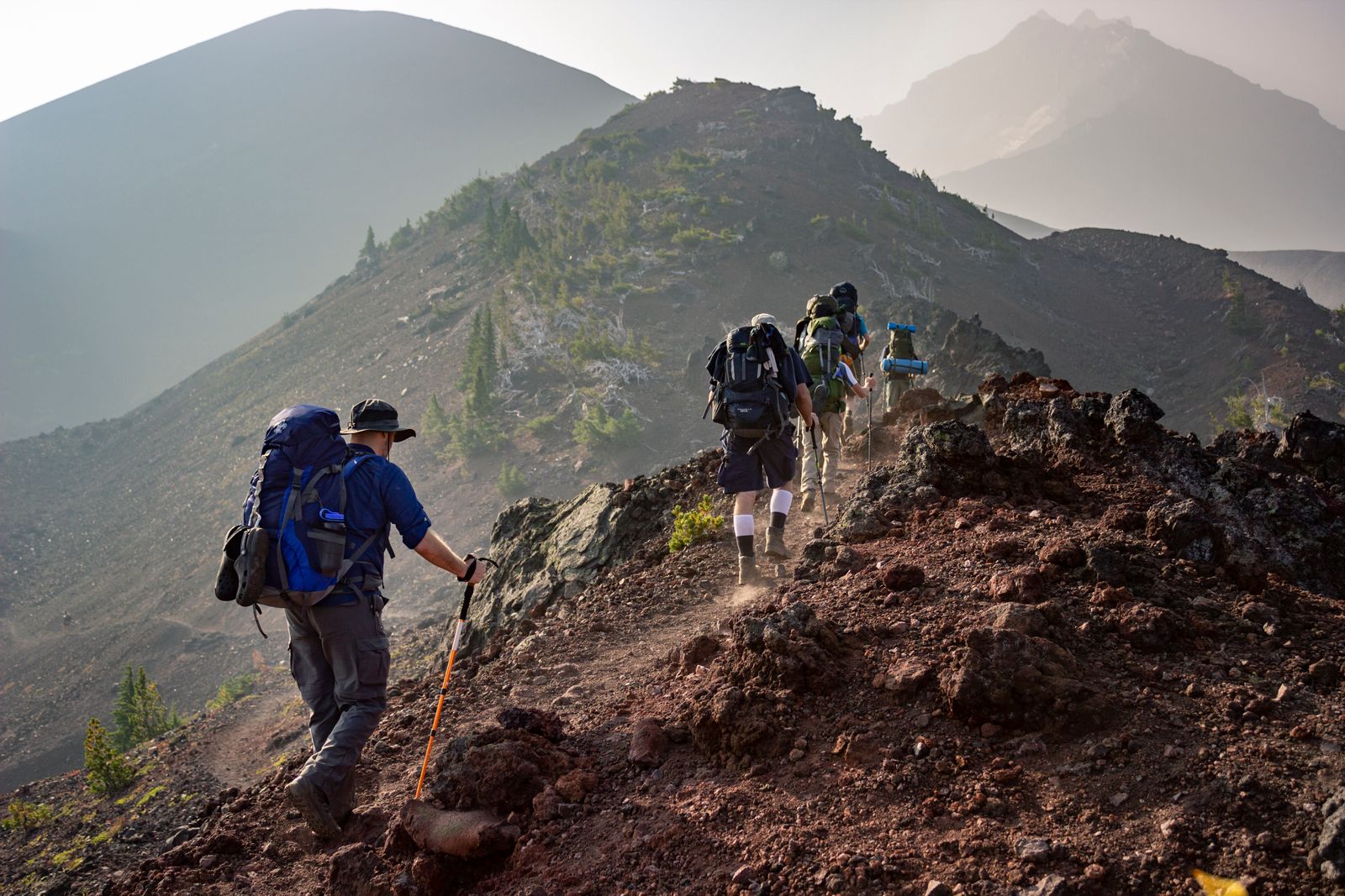 Hiking boots on a rocky trail — hiking boots vs trail runners comparison hero