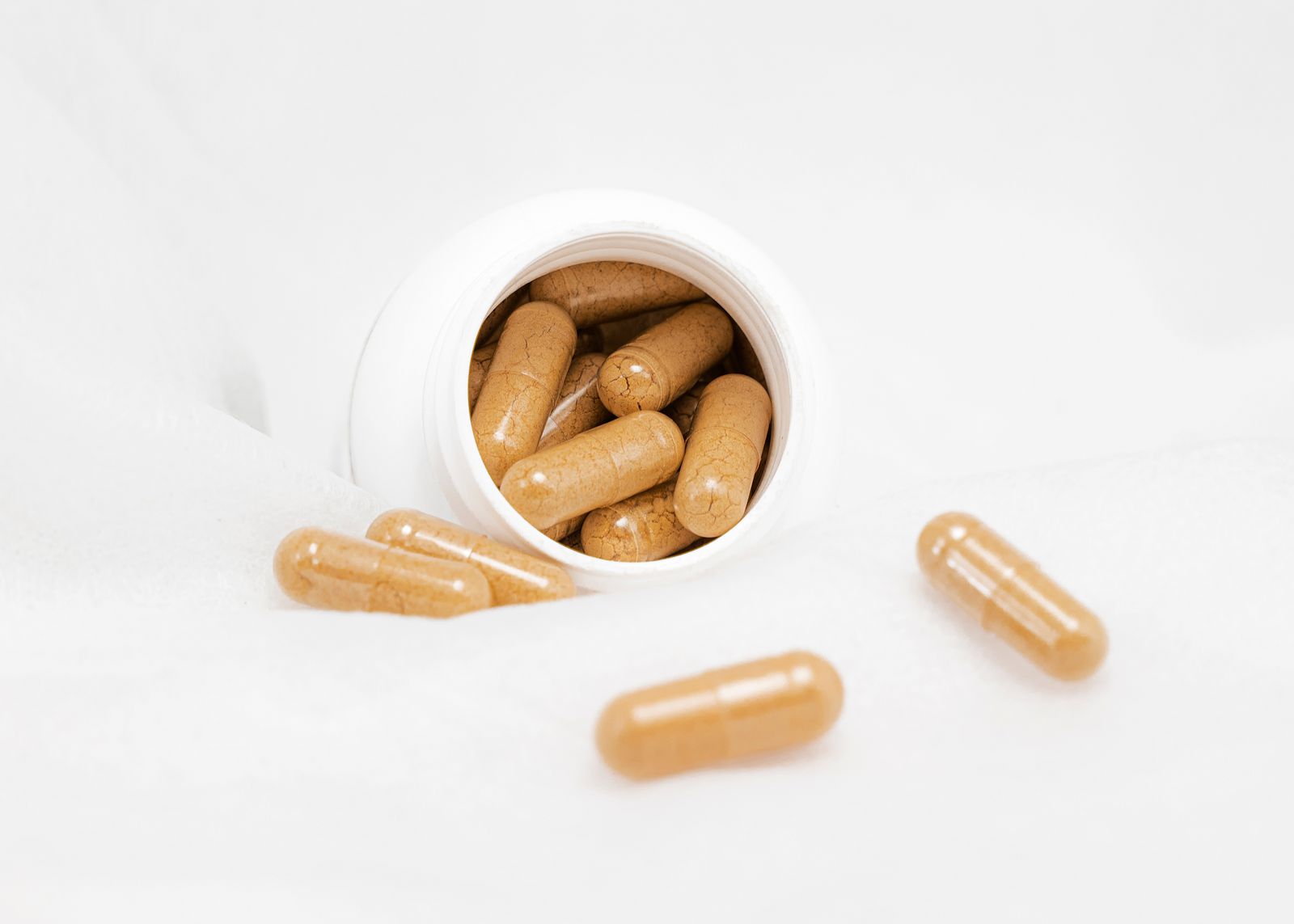Daily multivitamin pills in an open bottle