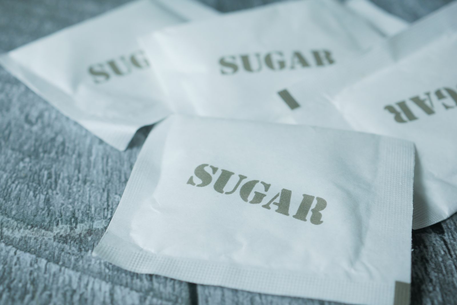Close-up of small sweetener packets on a table