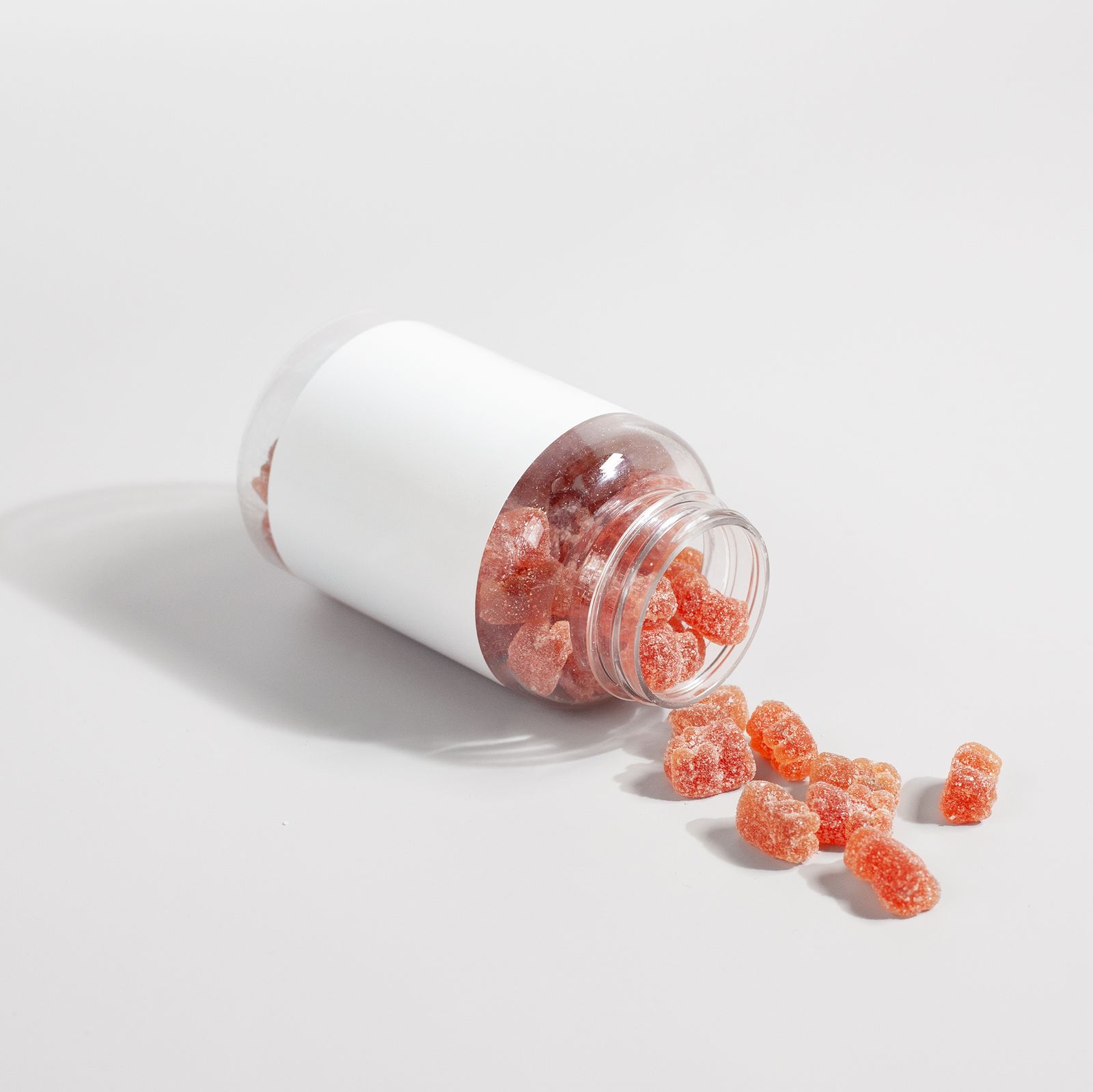 Close-up of supplement gummies on a white surface