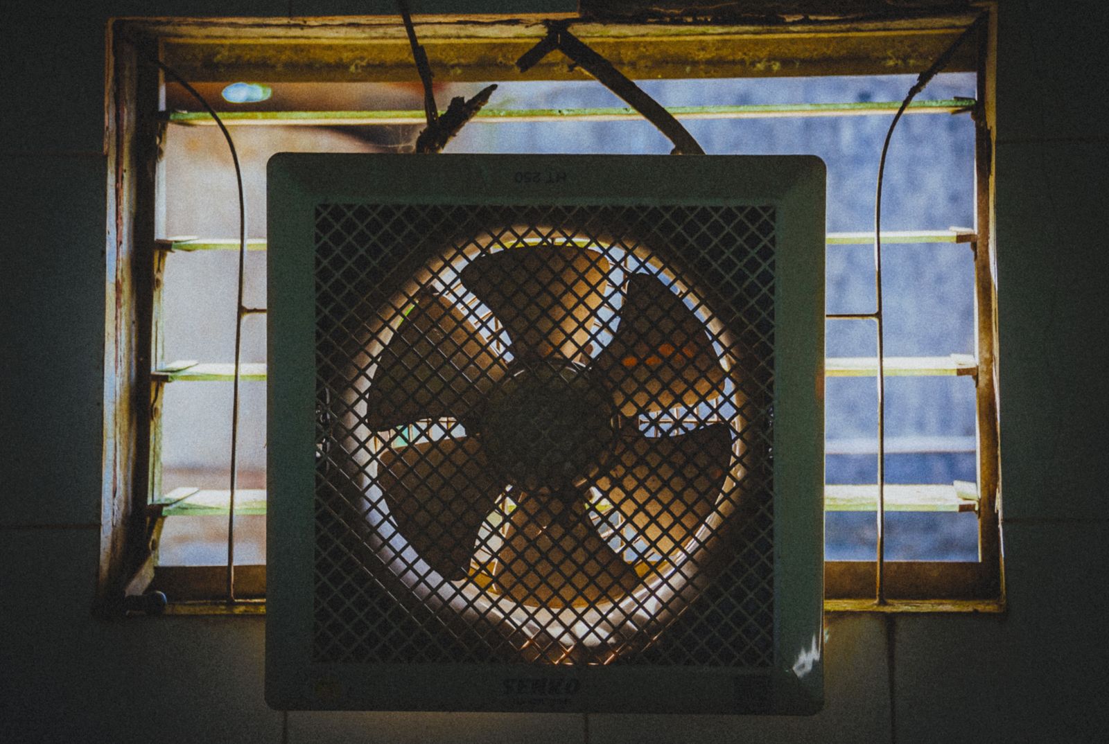 Evaporative cooler beside an open window in a bright dry-climate room