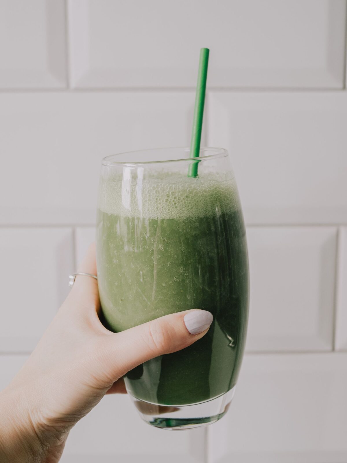 Glass of green smoothie made from blended greens