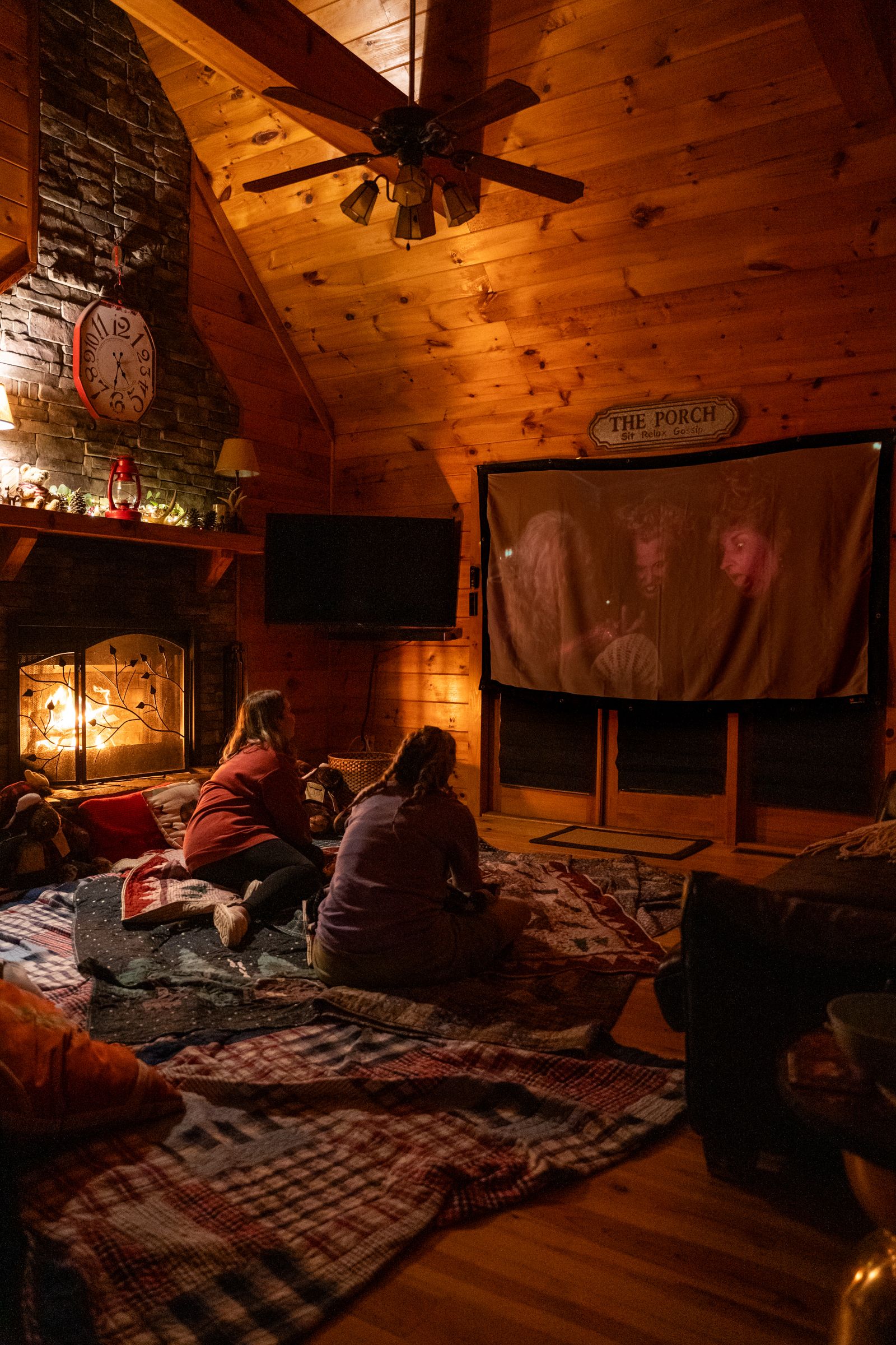 Two girls watching TV together in a cozy living room