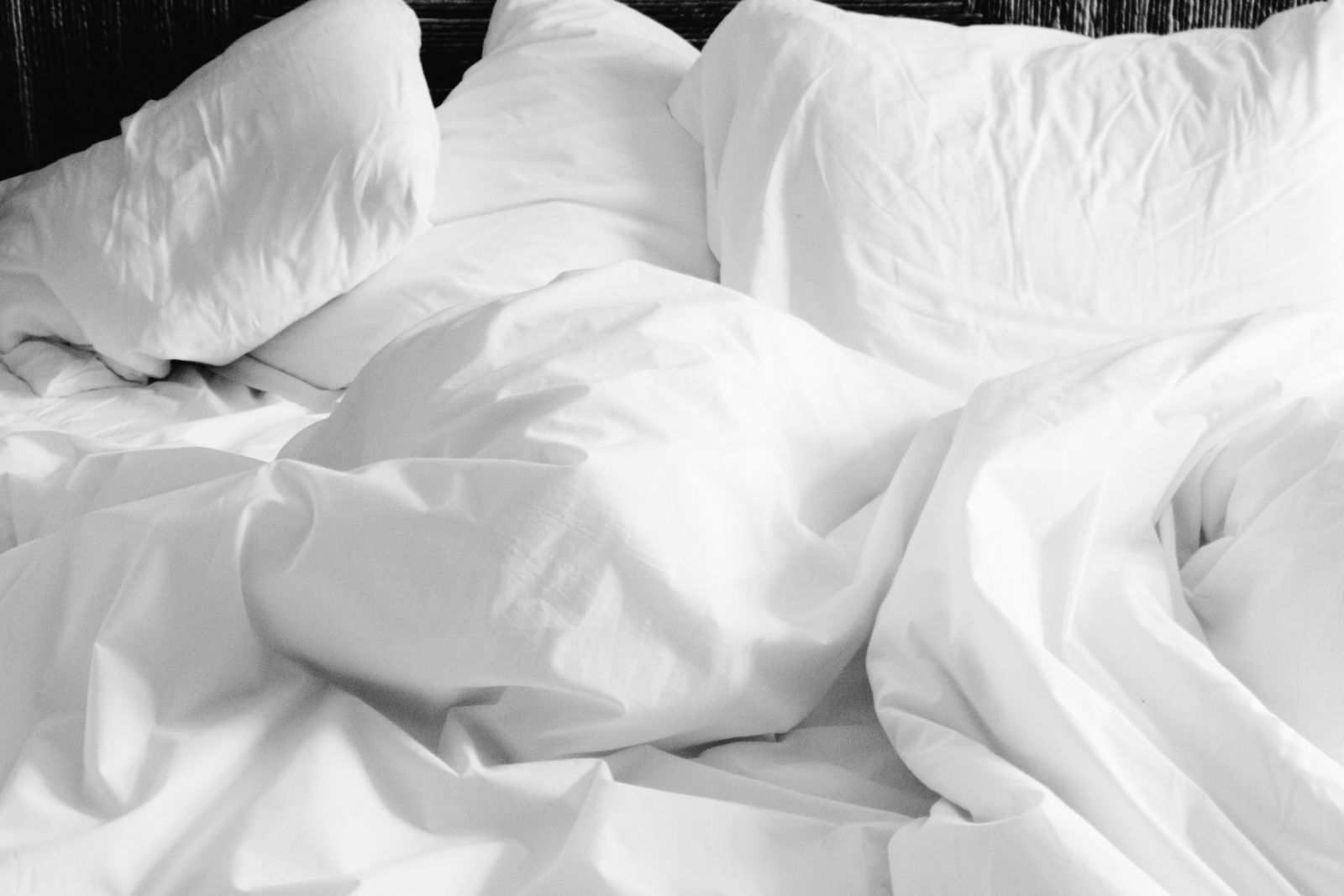Neatly made bed with a white comforter