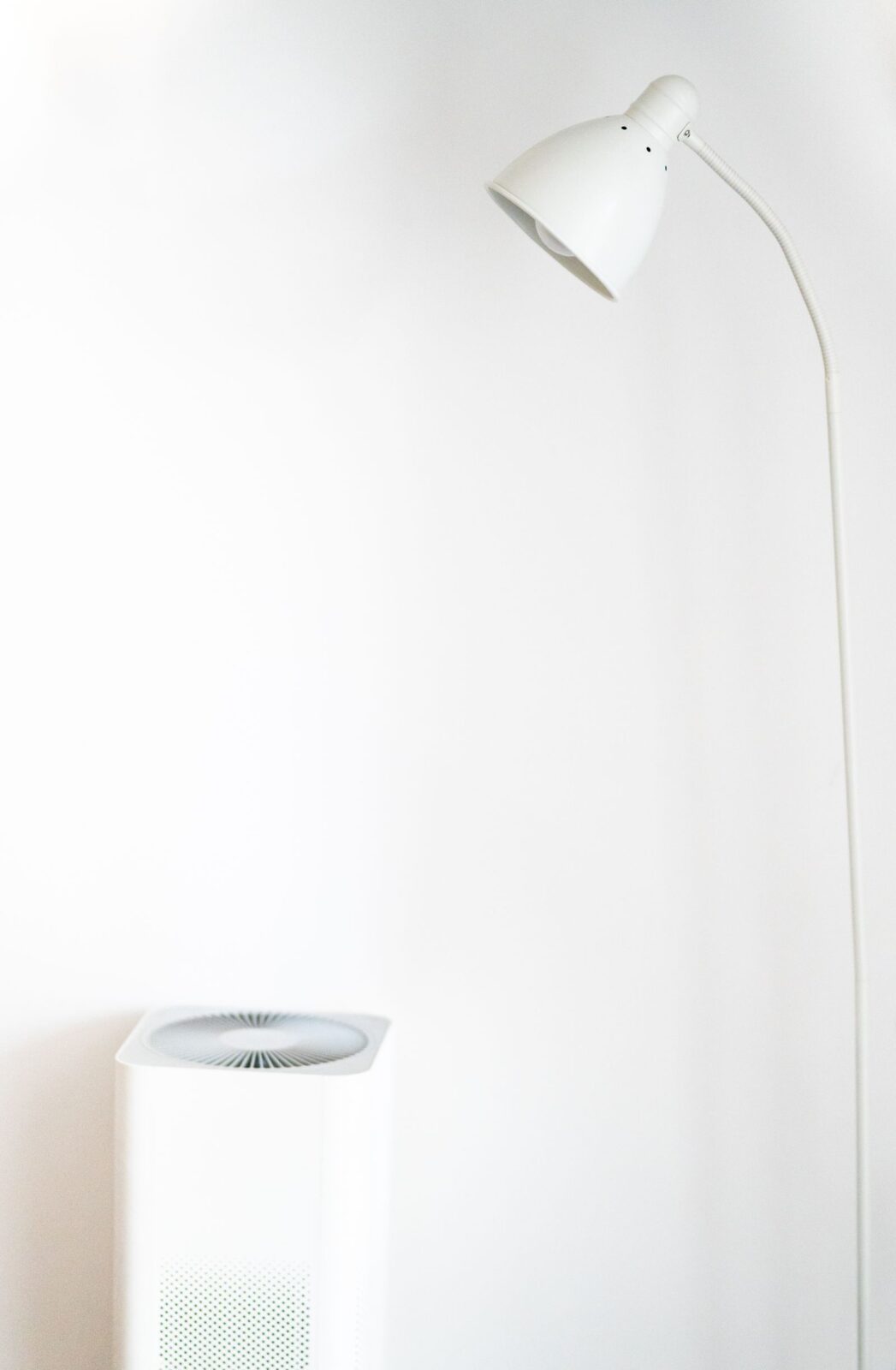 Compact air purifier beside a bed in a calm bedroom