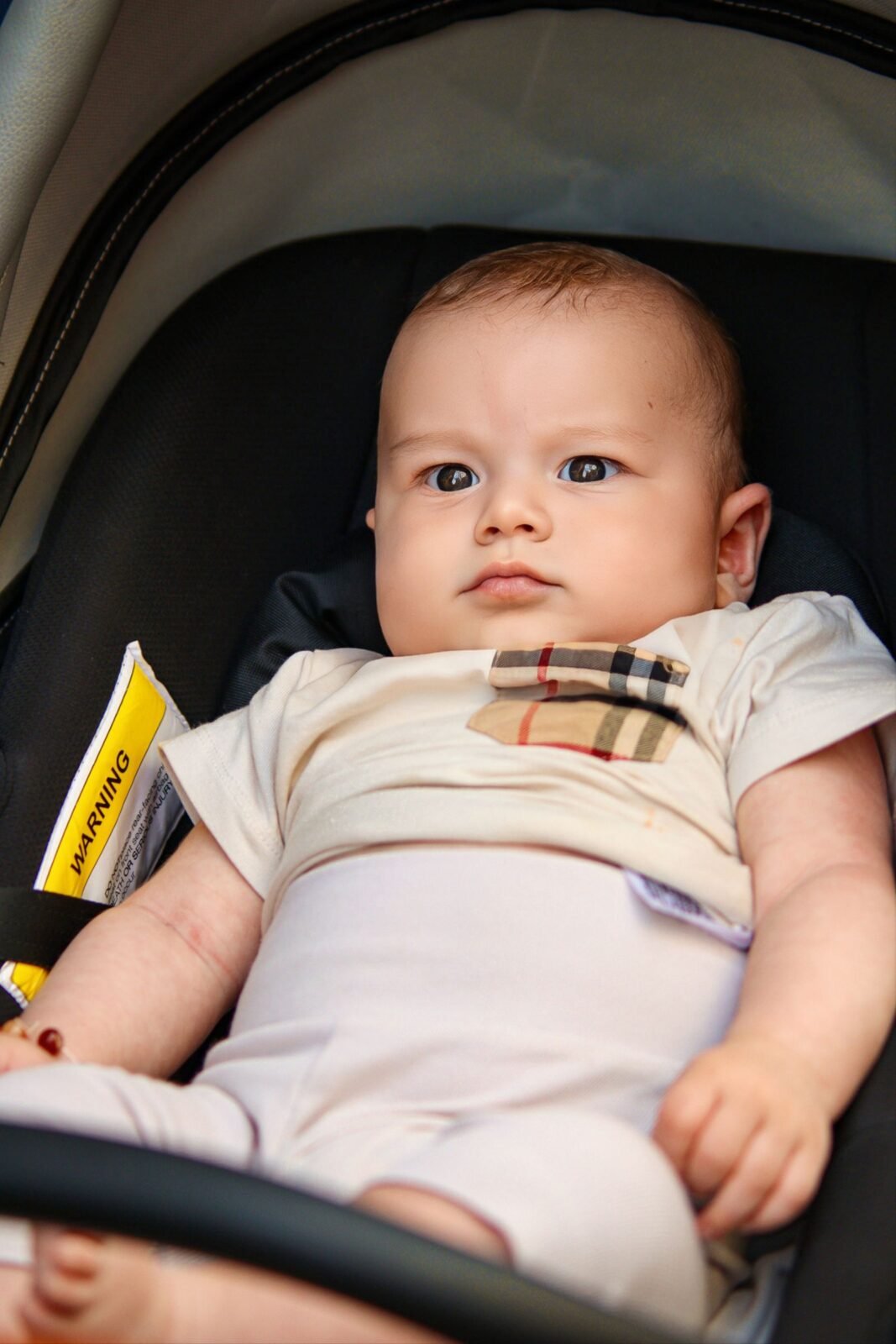 A baby sitting in a stroller