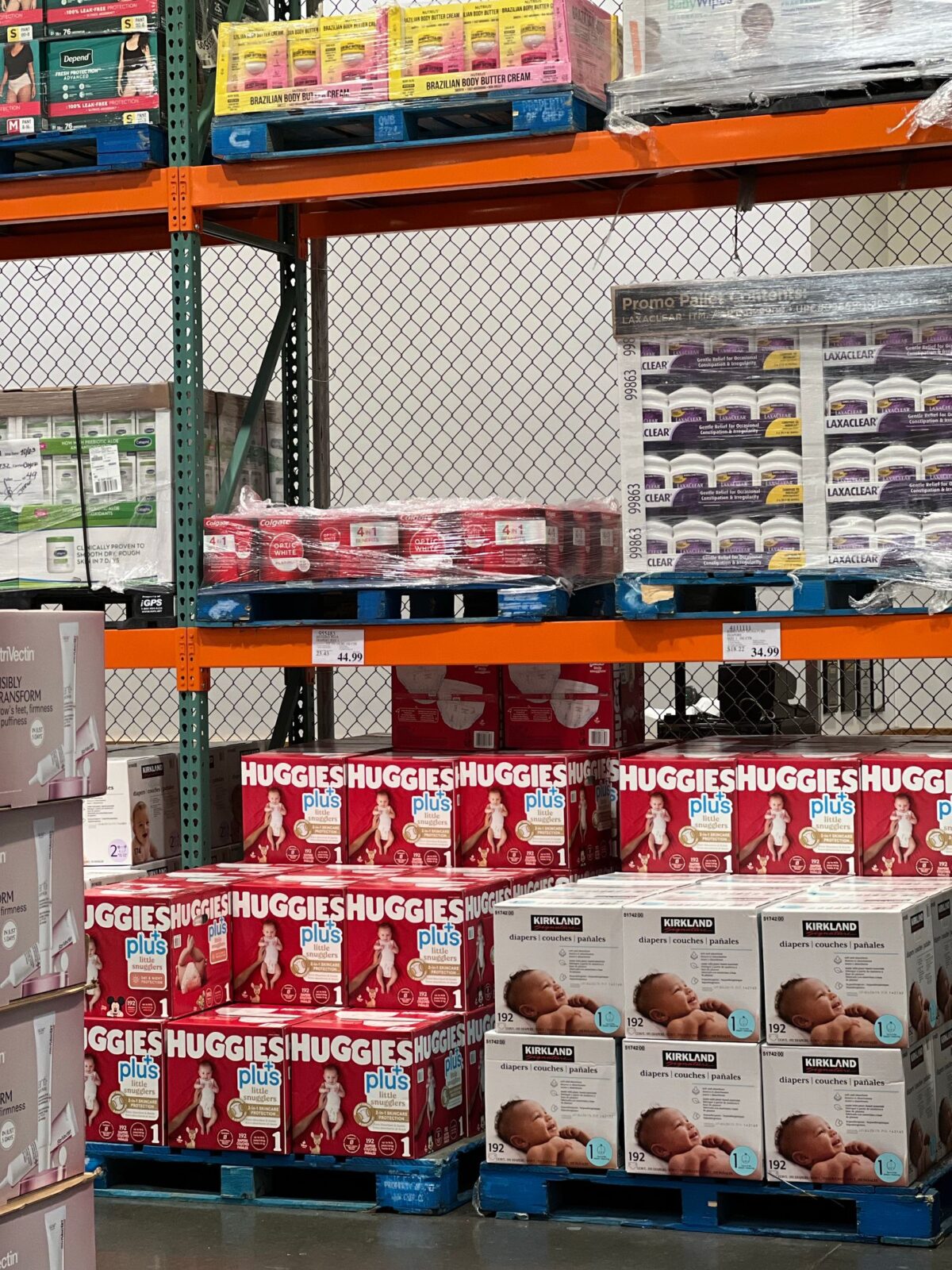 Neat stack of plain white disposable diapers on a nursery dresser