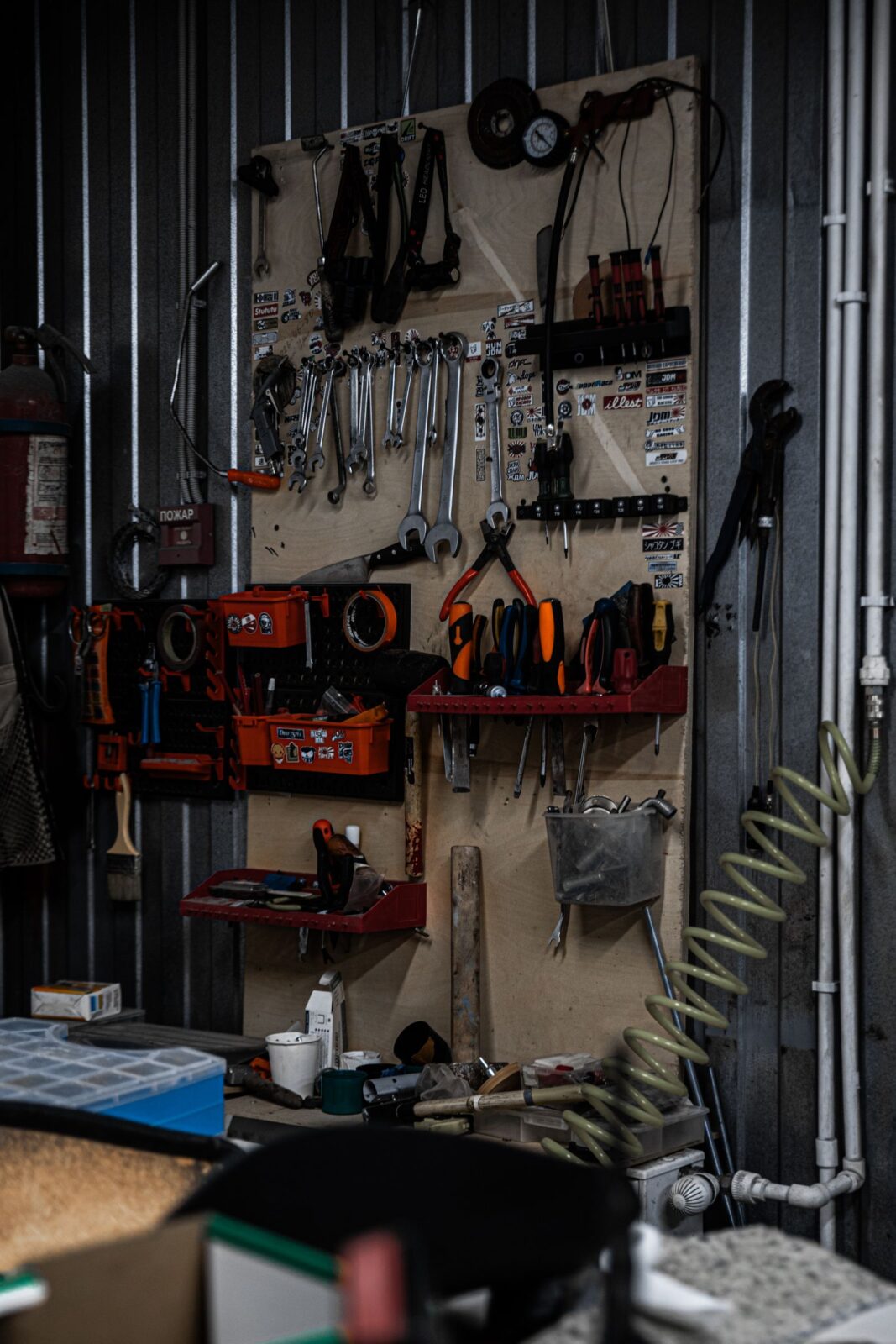 Garage steel track rail system holding bikes, a ladder, and bulky gear off the floor
