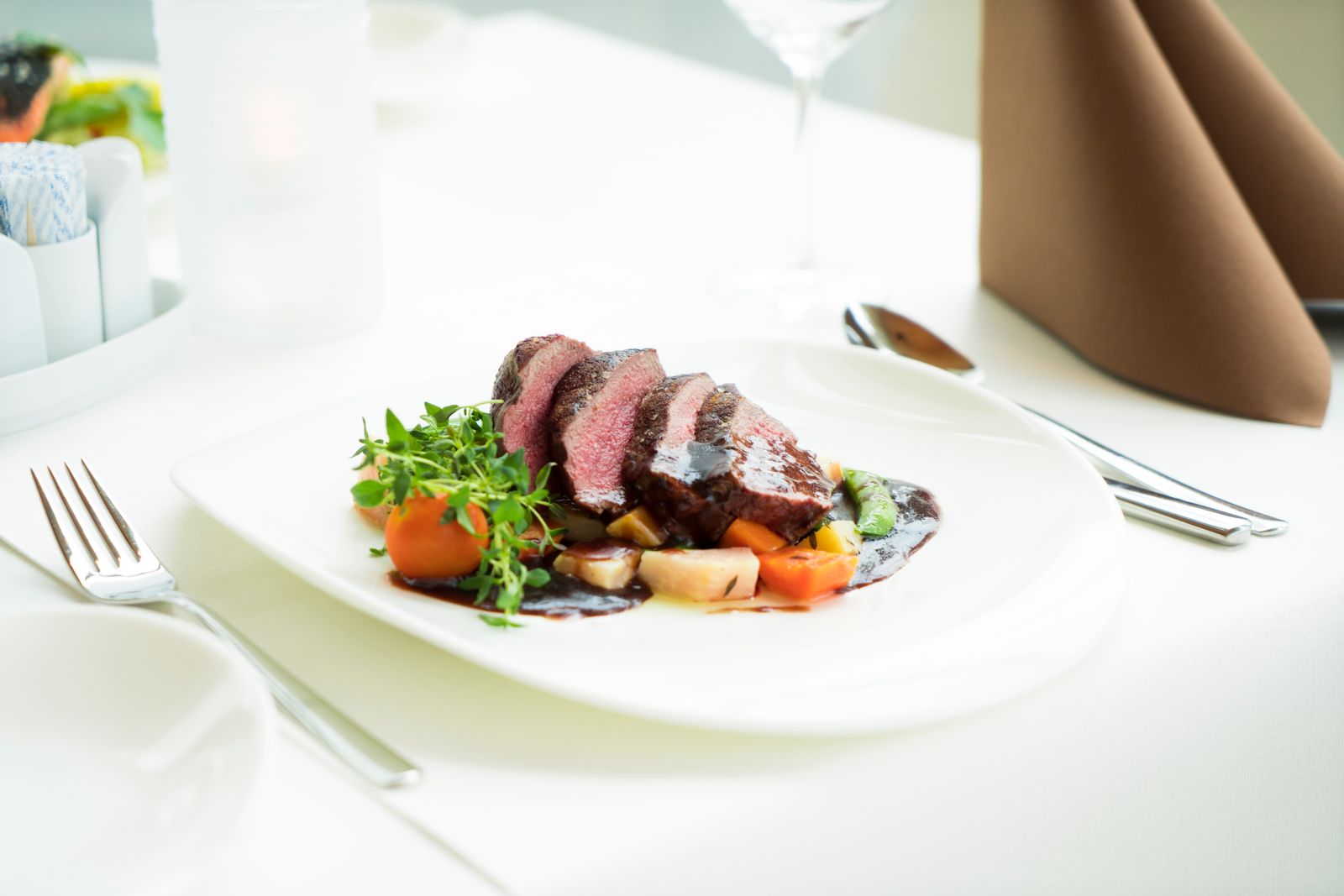 Perfectly cooked sliced steak on a plate — sous vide cooker comparison hero