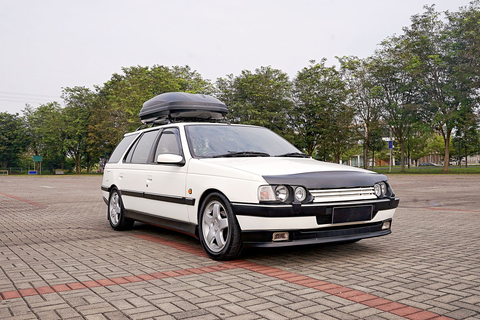 A car carrying a rooftop cargo box loaded for a road trip