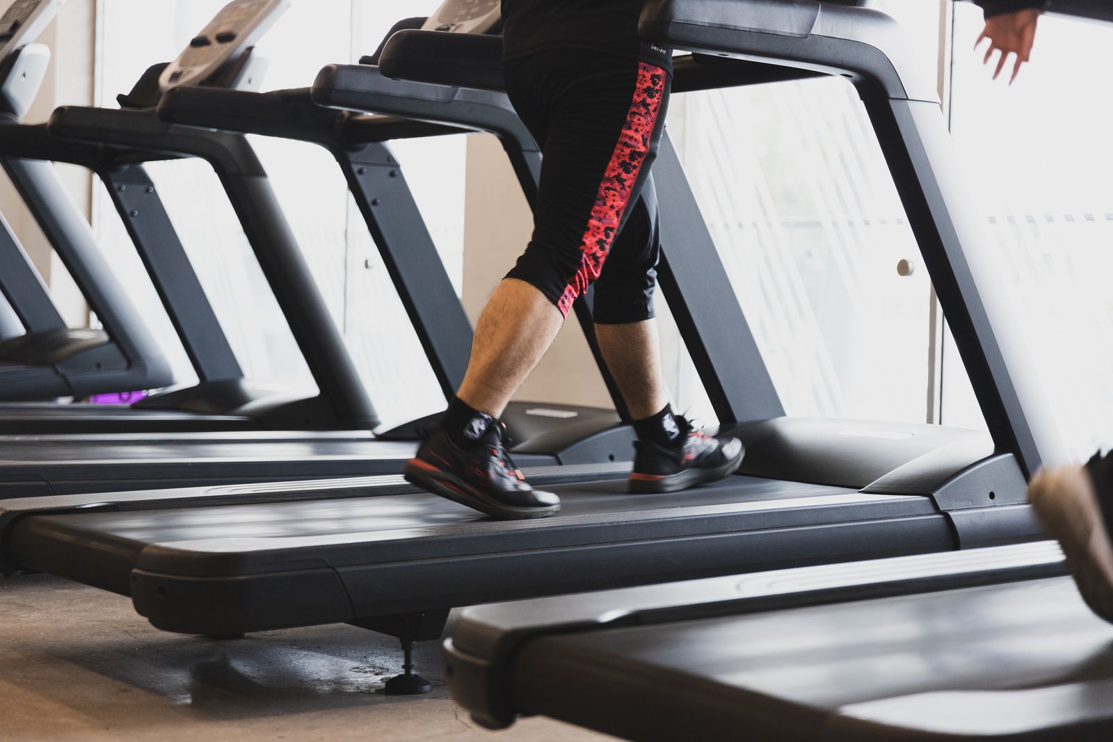 Person walking on a low-profile treadmill