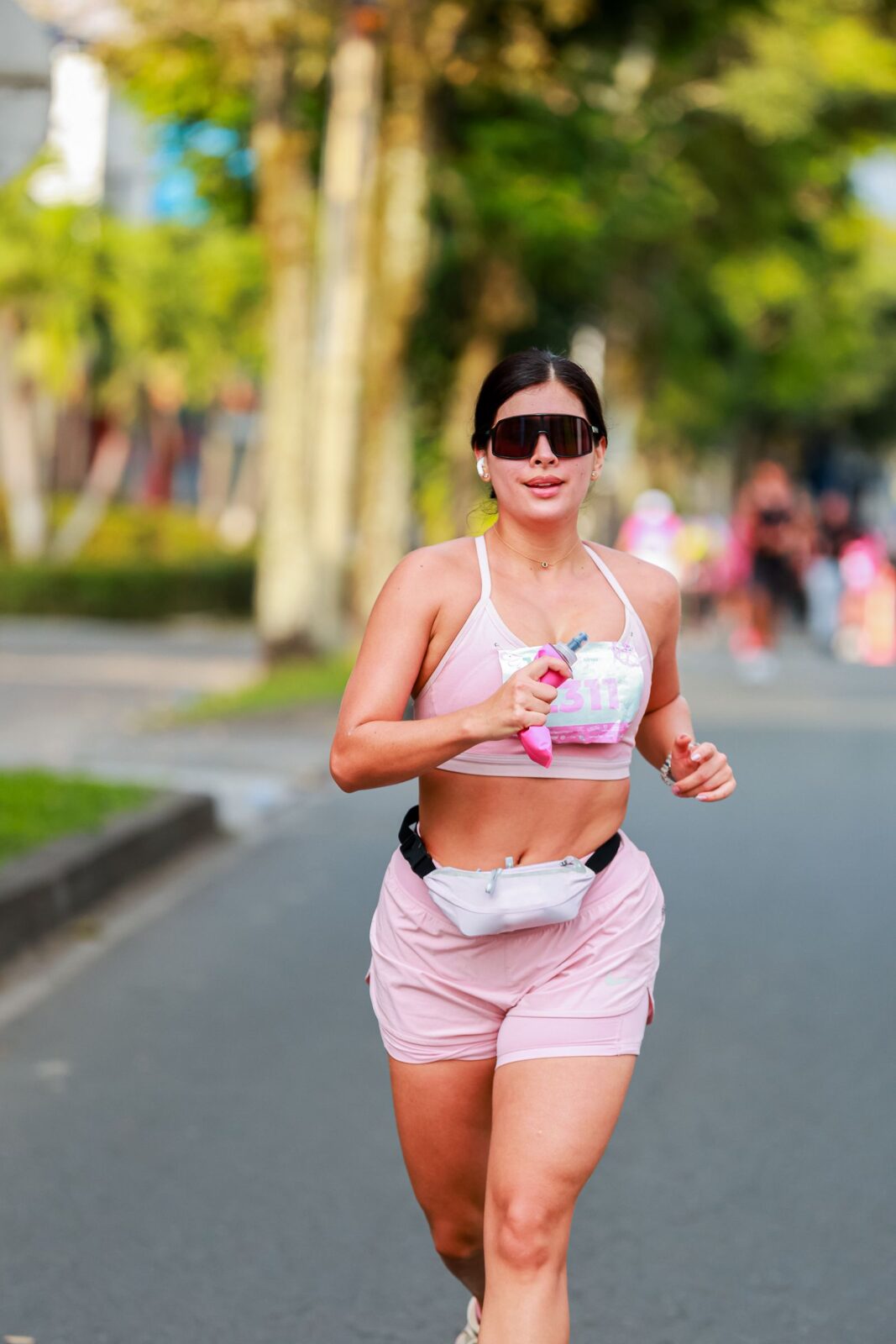 A woman jogging outdoors in bright activewear