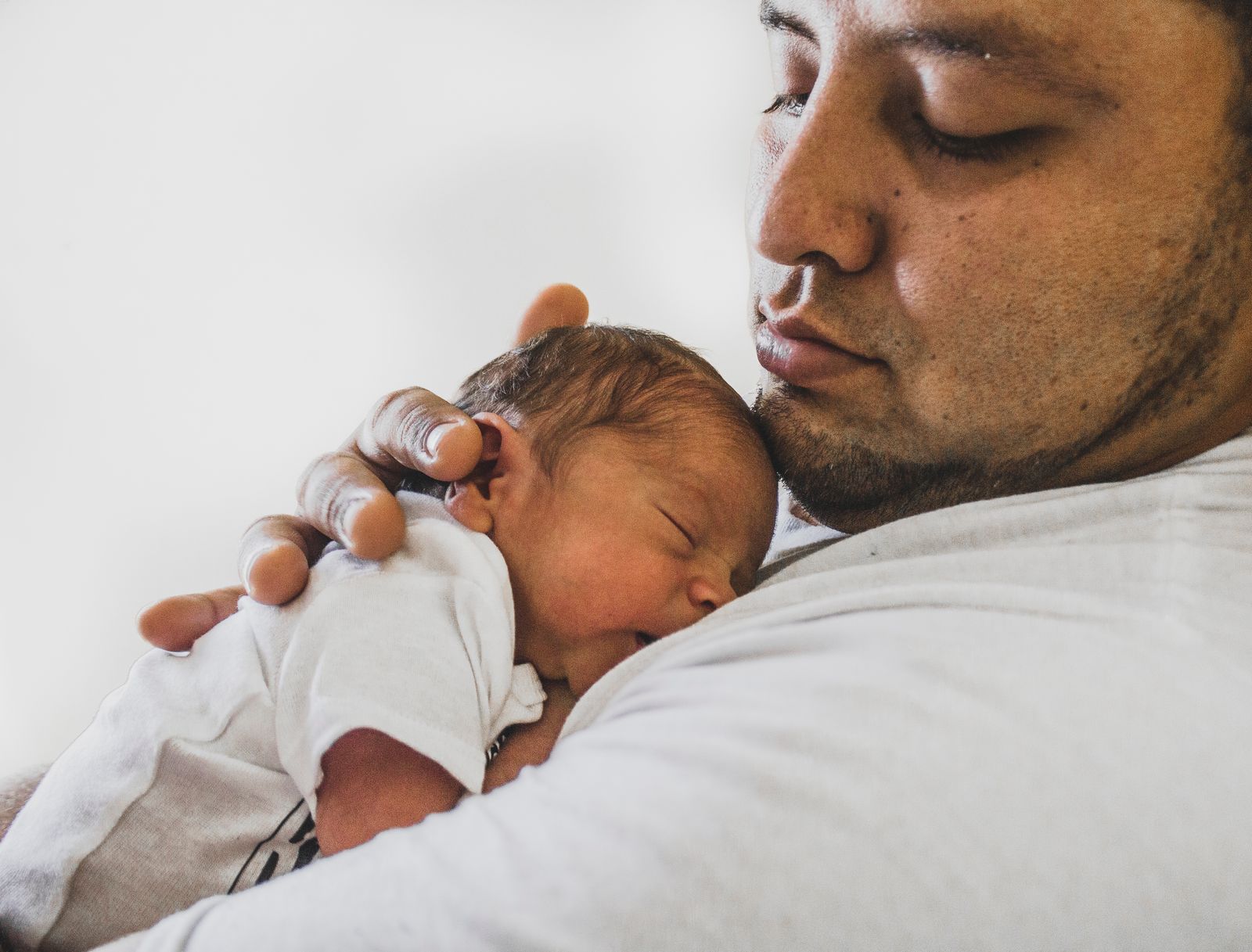 Parent carrying a young child against the chest