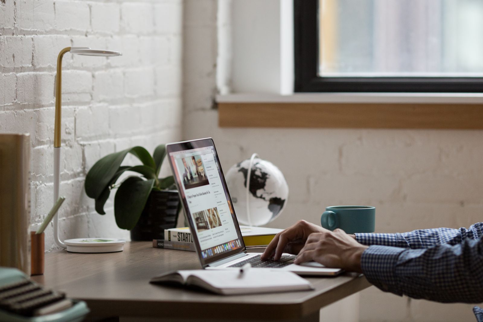Person using a laptop for everyday web tasks at a desk