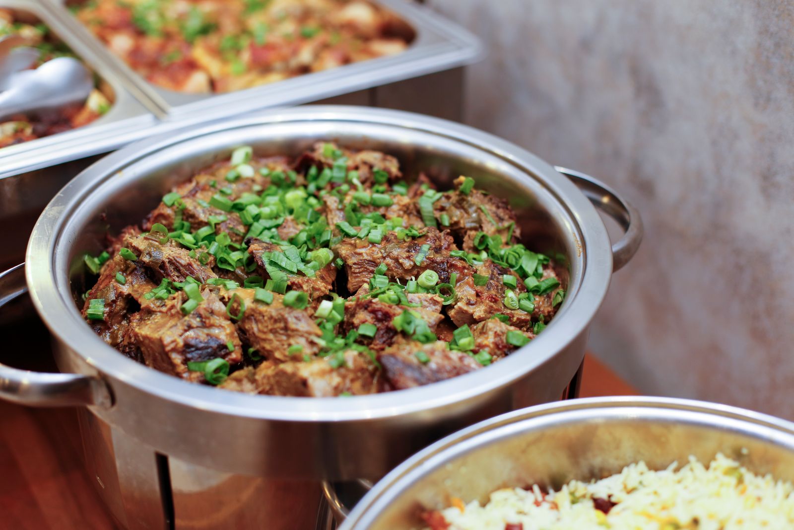 A stainless steel cooking pot filled with food