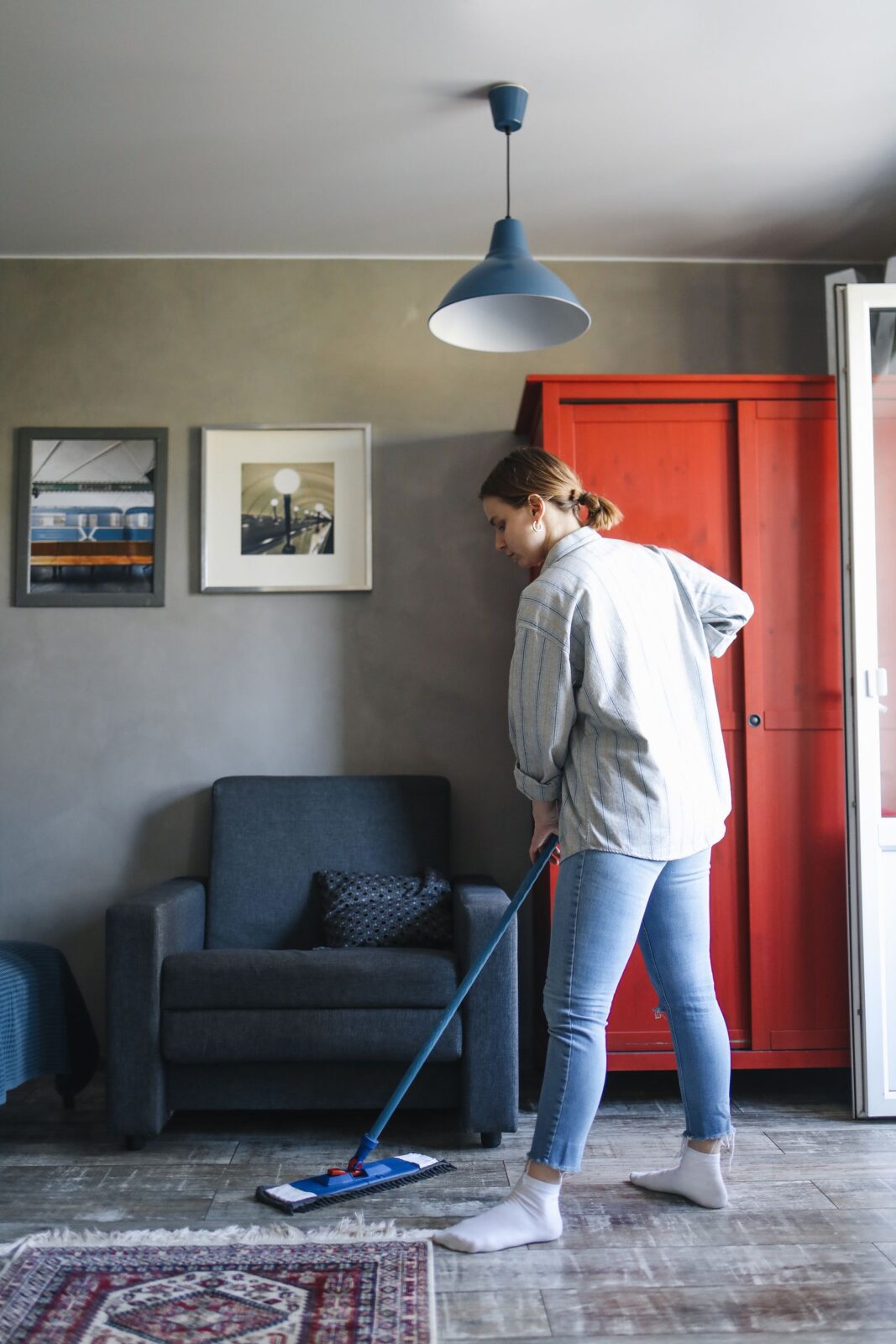 Person mopping a hard floor at home — wet dry vacuum mop buyer's guide hero