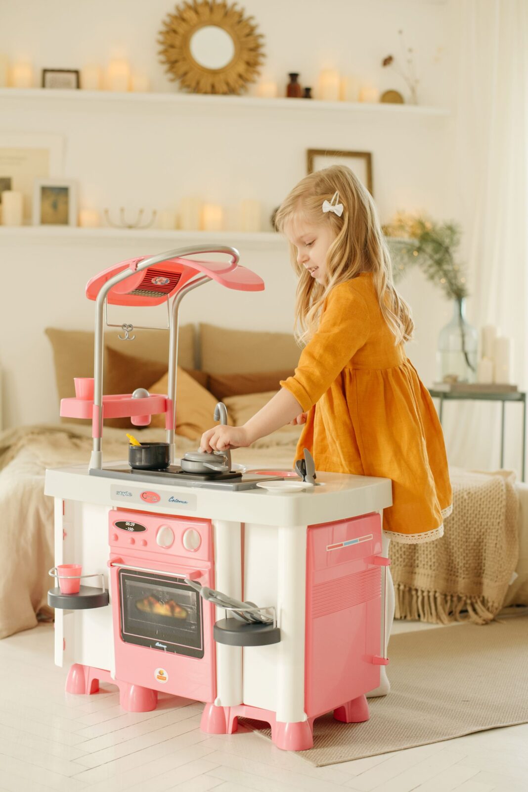 Child cooking pretend meals at a plastic play kitchen
