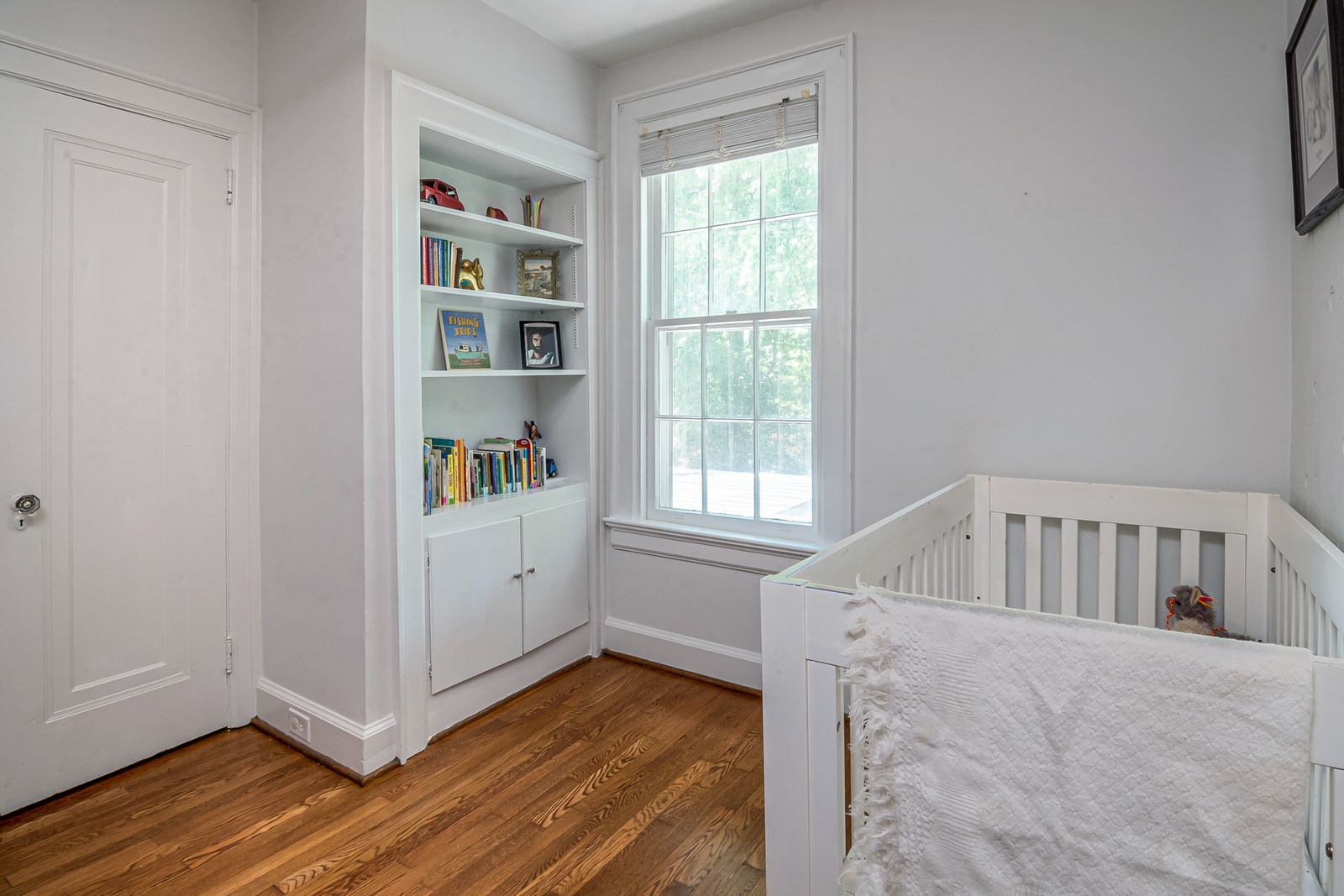 A compact bedside bassinet next to a bed