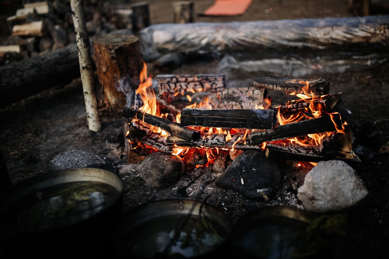 Close-up of burning firewood and logs in an outdoor fire pit