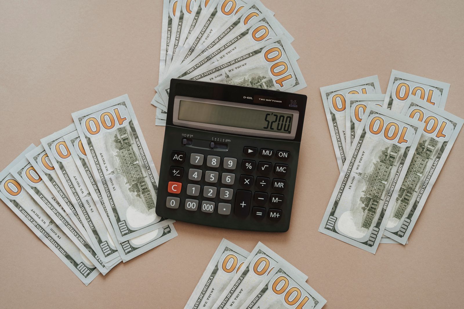 A measuring tape, calculator, and coins representing healthcare budgeting