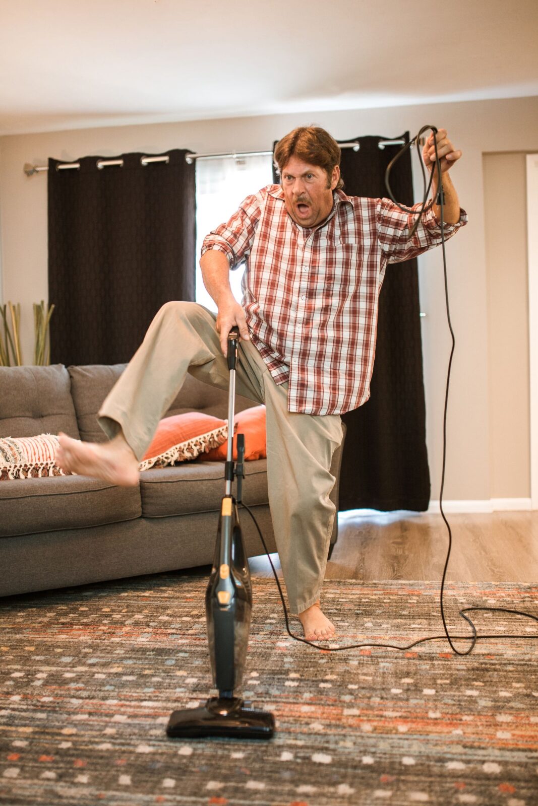 Person vacuuming carpet showing suction across floor surfaces
