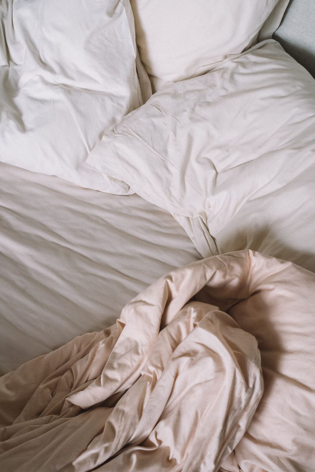 An air mattress with bedding set up on a bedroom floor