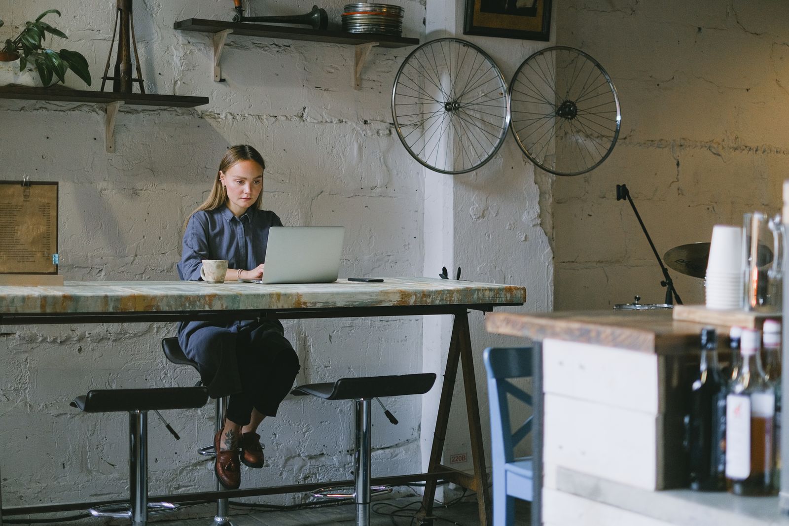 A person working remotely on a laptop with a cup of coffee