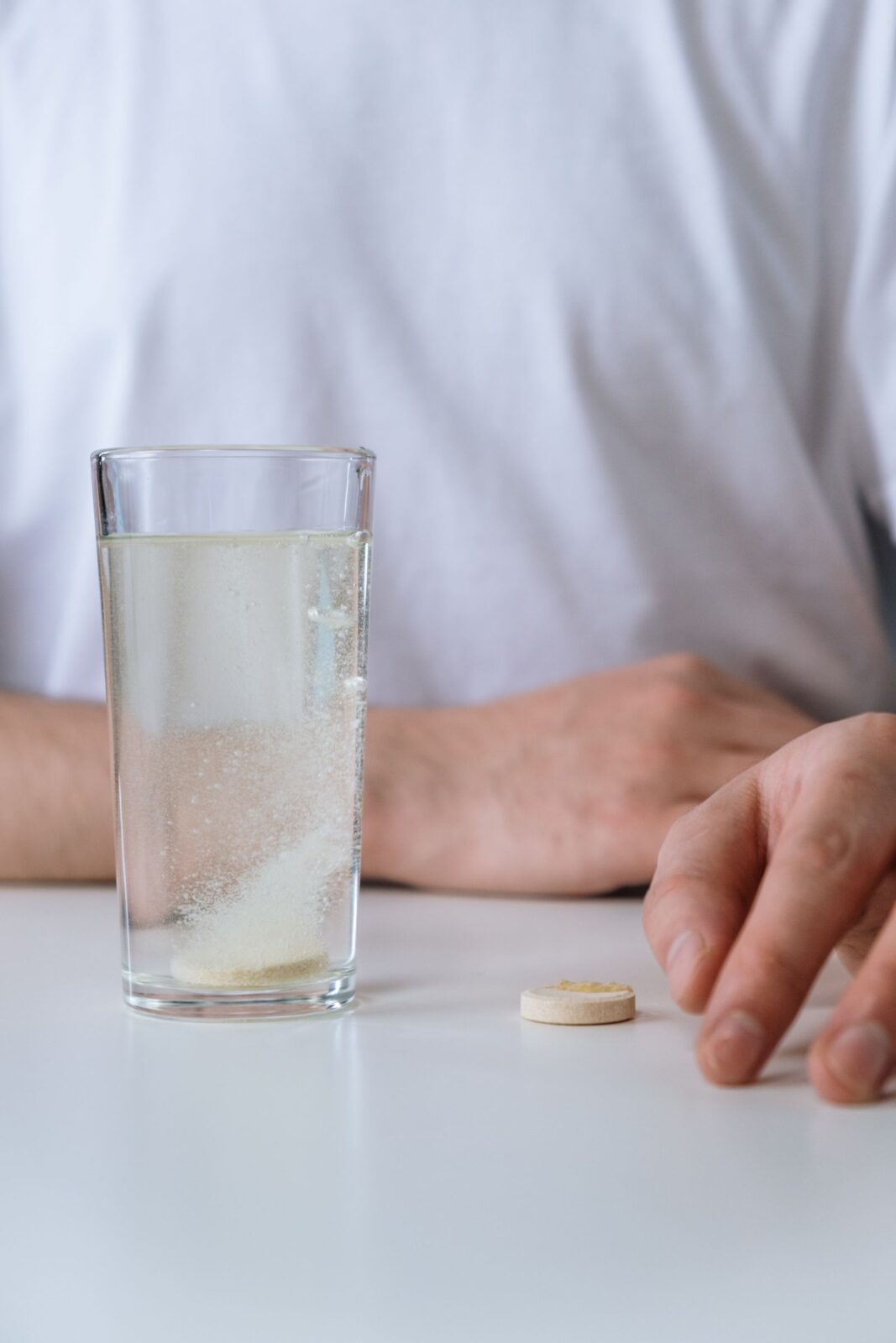 A supplement tablet dissolving in a glass of water