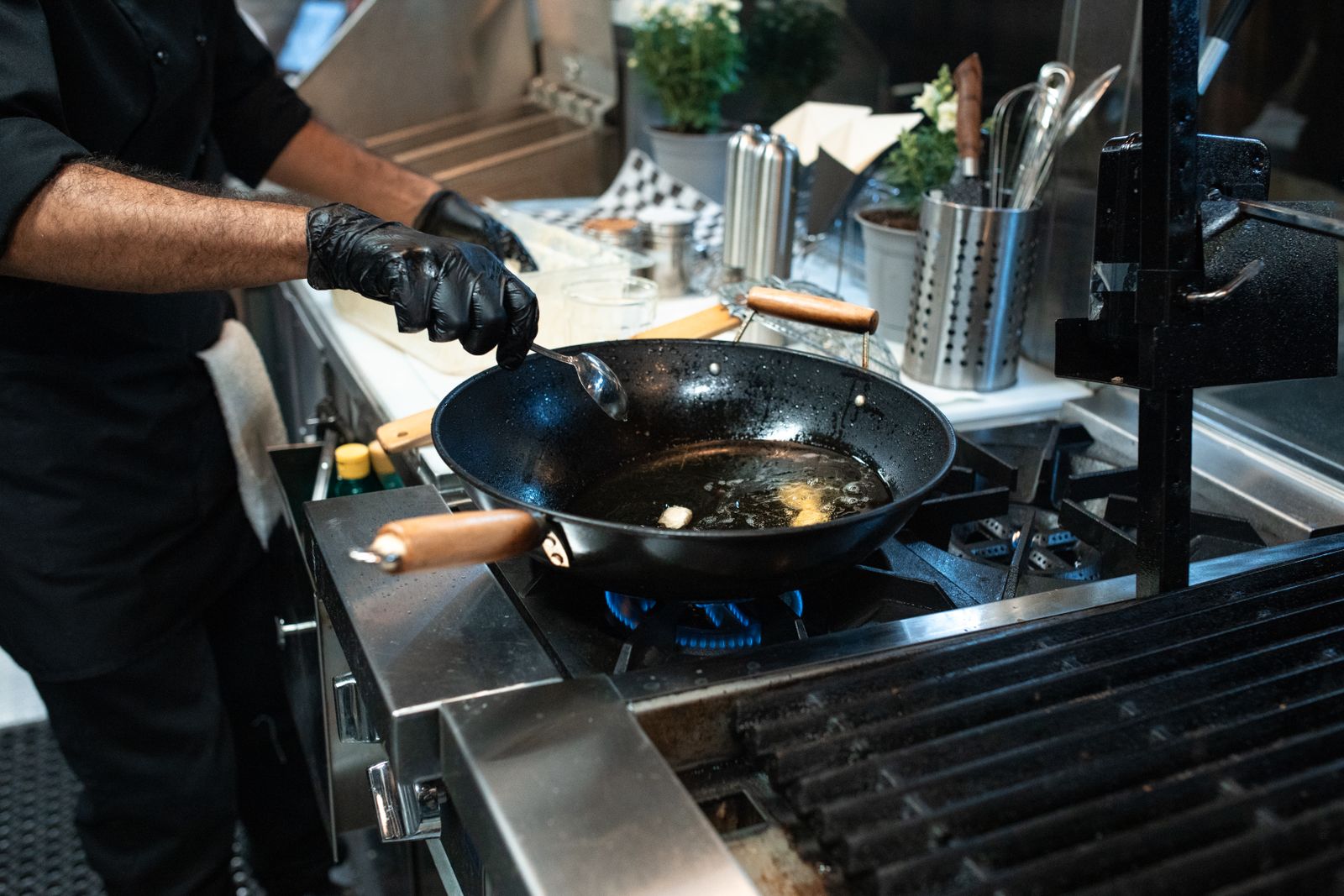 A stainless steel skillet searing a steak with golden browning