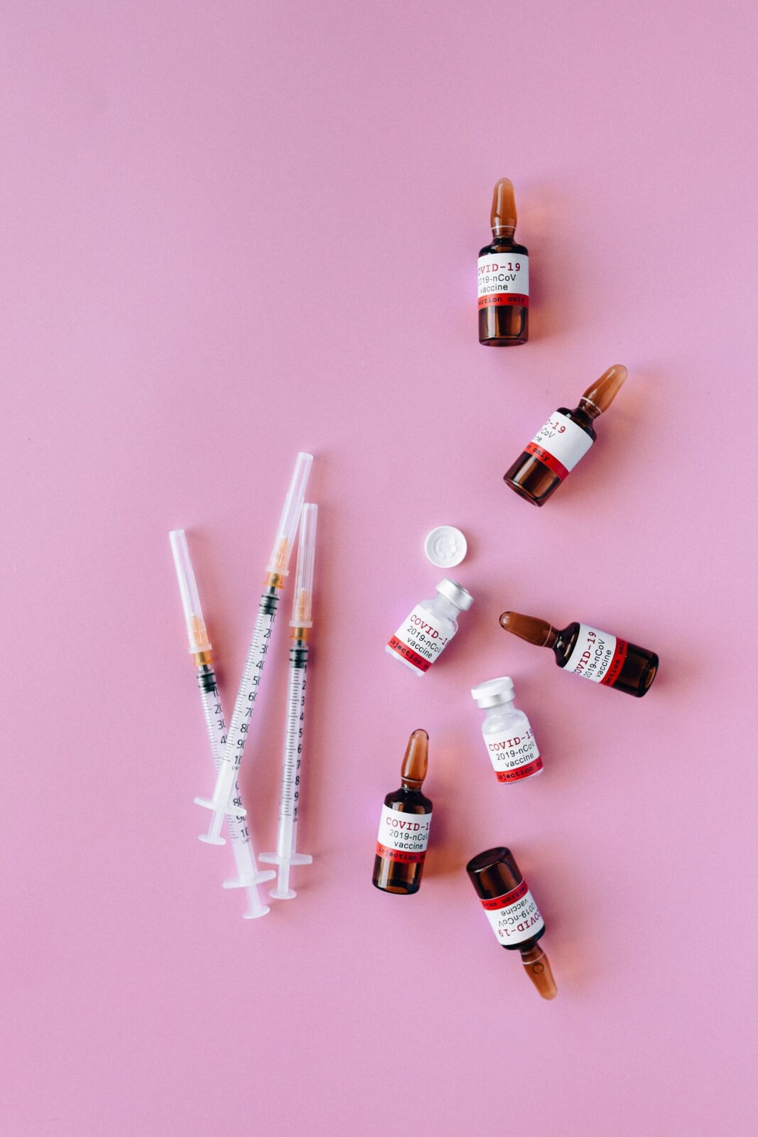Unbranded medication vials and a syringe on a pharmacy counter