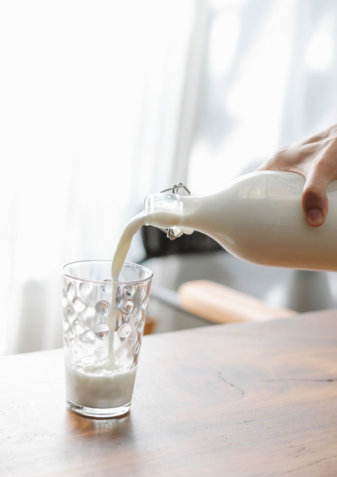 Milk being poured into a glass, illustrating dairy-based protein