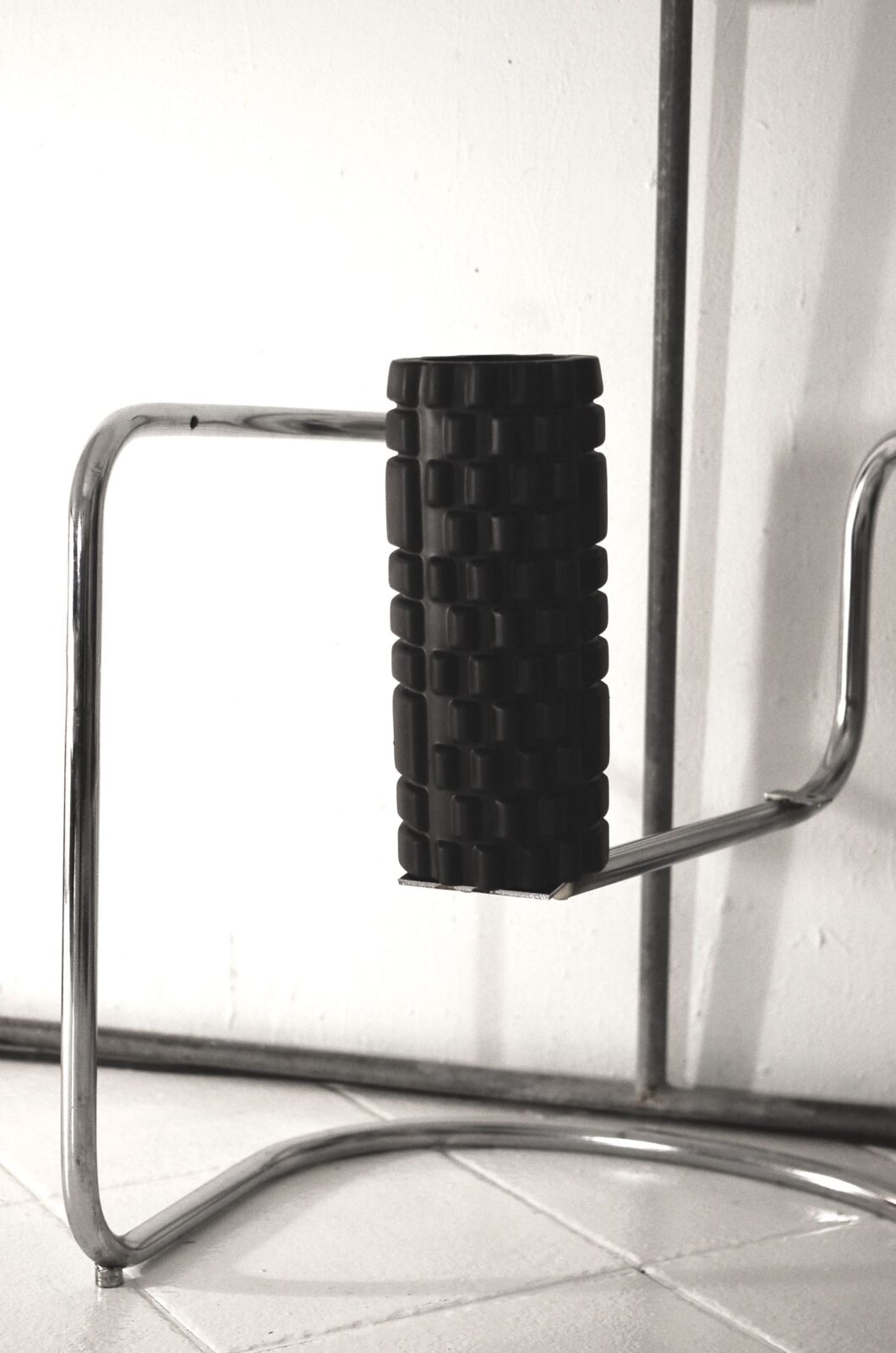 Muscle recovery equipment including a foam roller on a gym floor