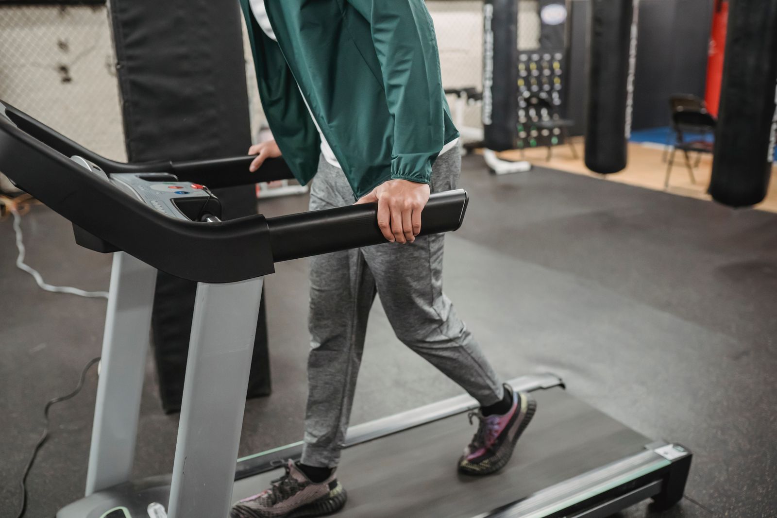 Man walking on a modern treadmill during a workout