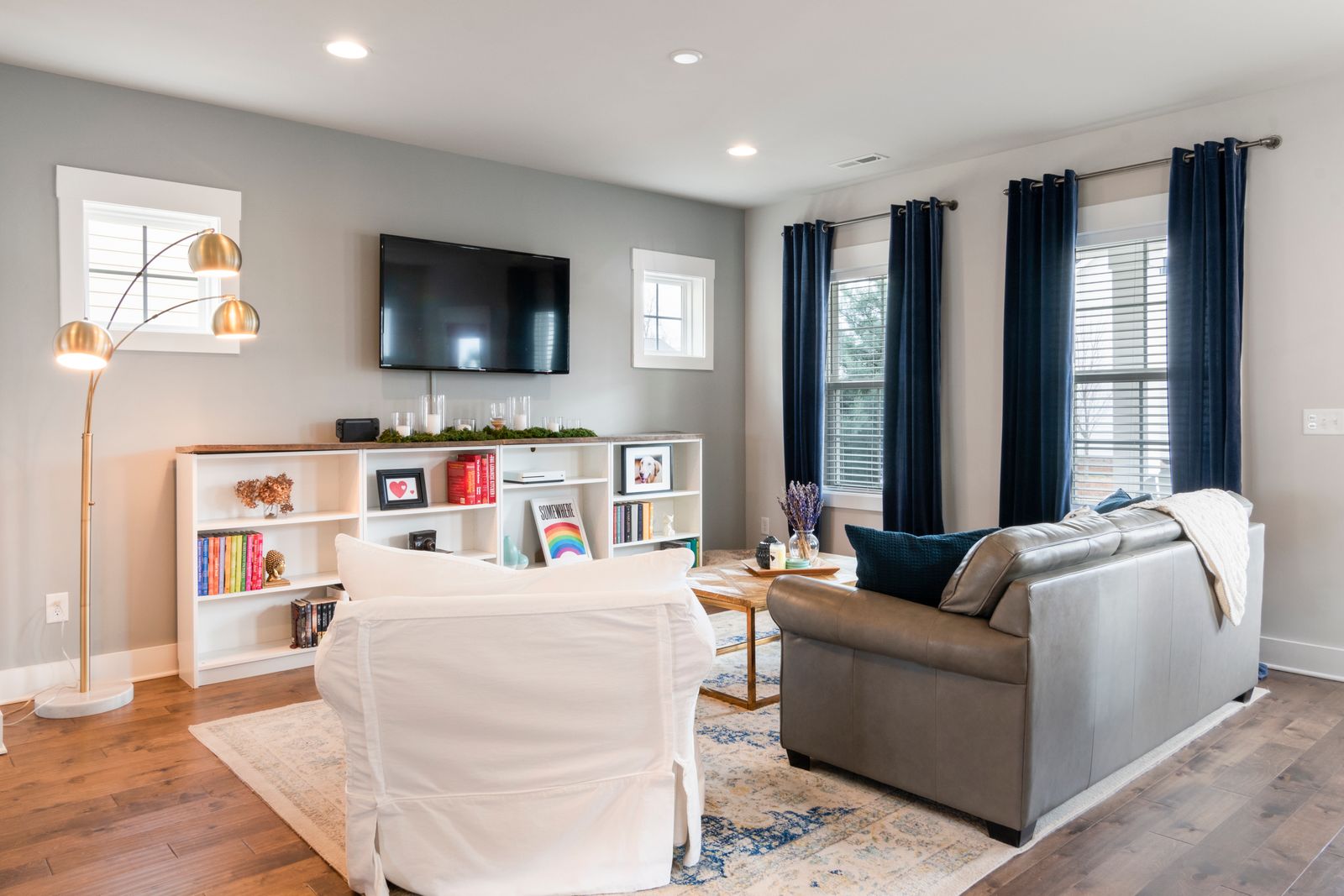 Sunlit living room window with elegant curtains and shades
