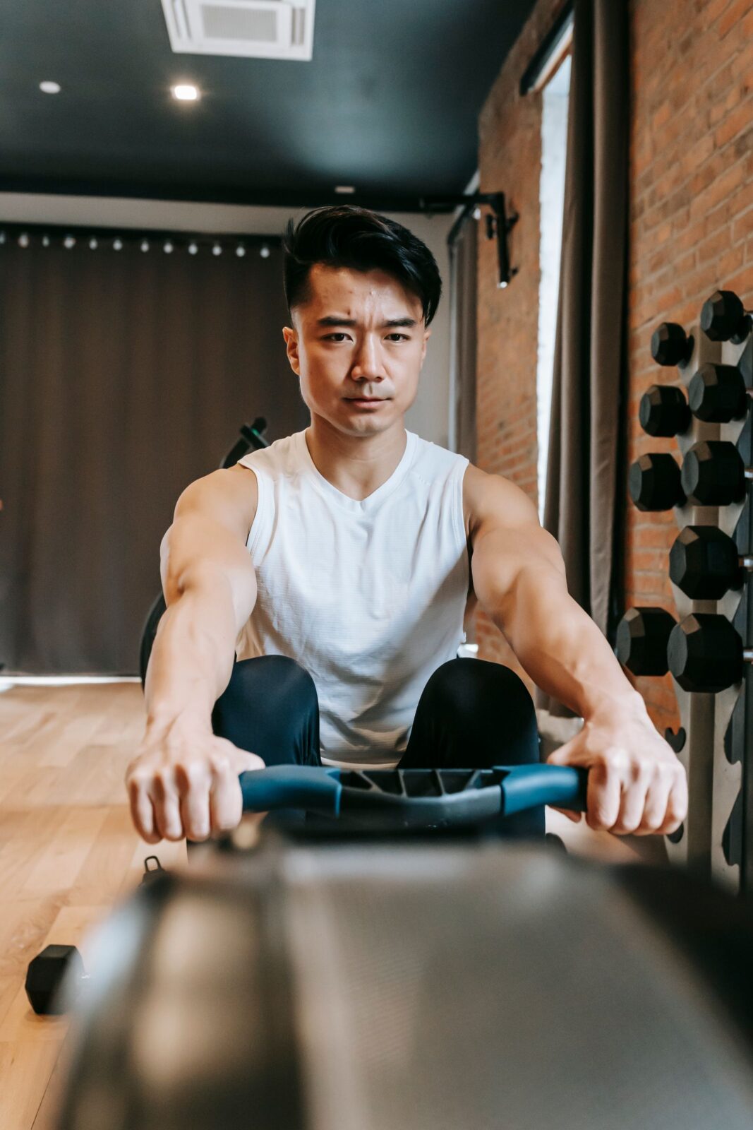 A person training on a rowing machine in a gym