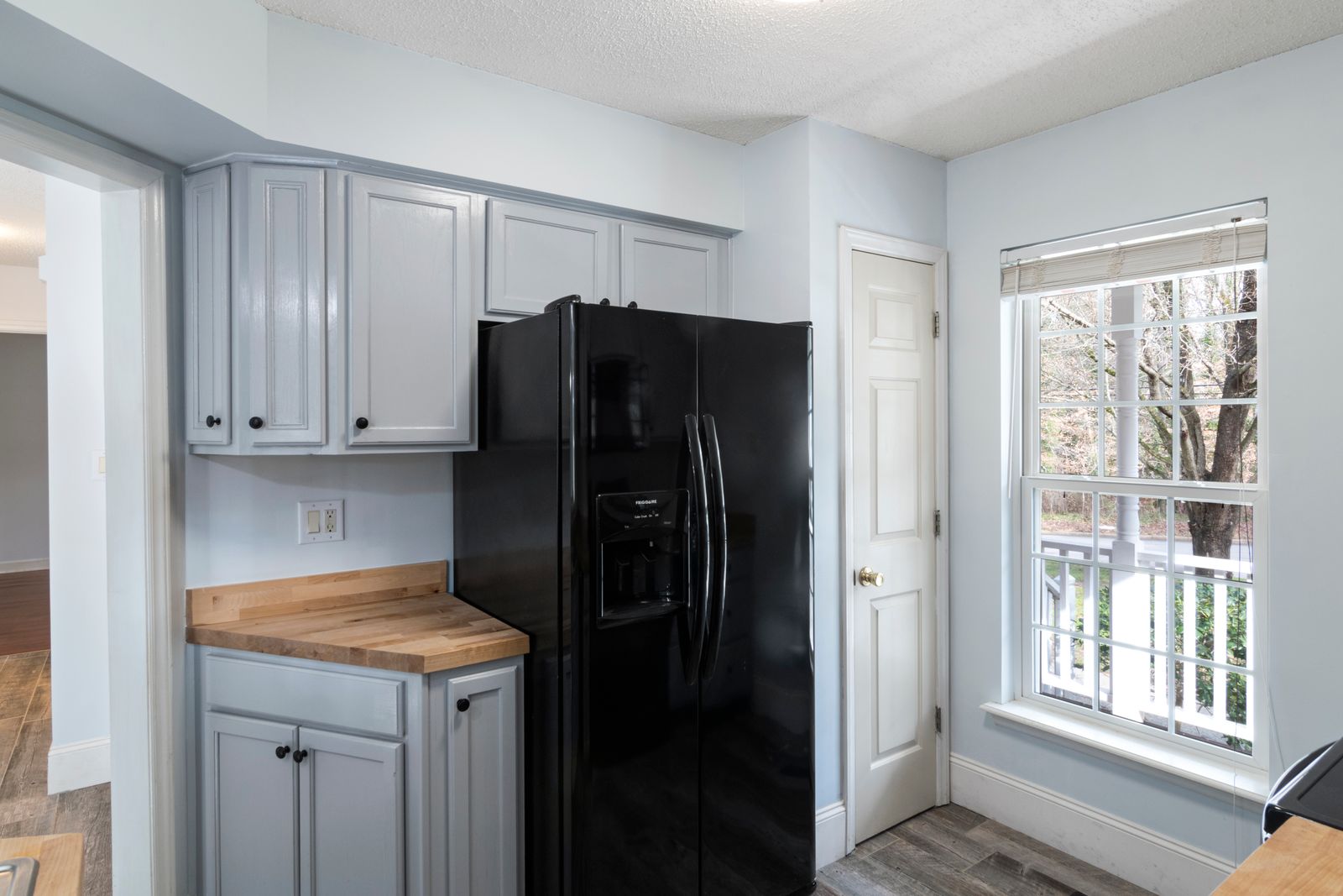 A compact refrigerator standing in a room