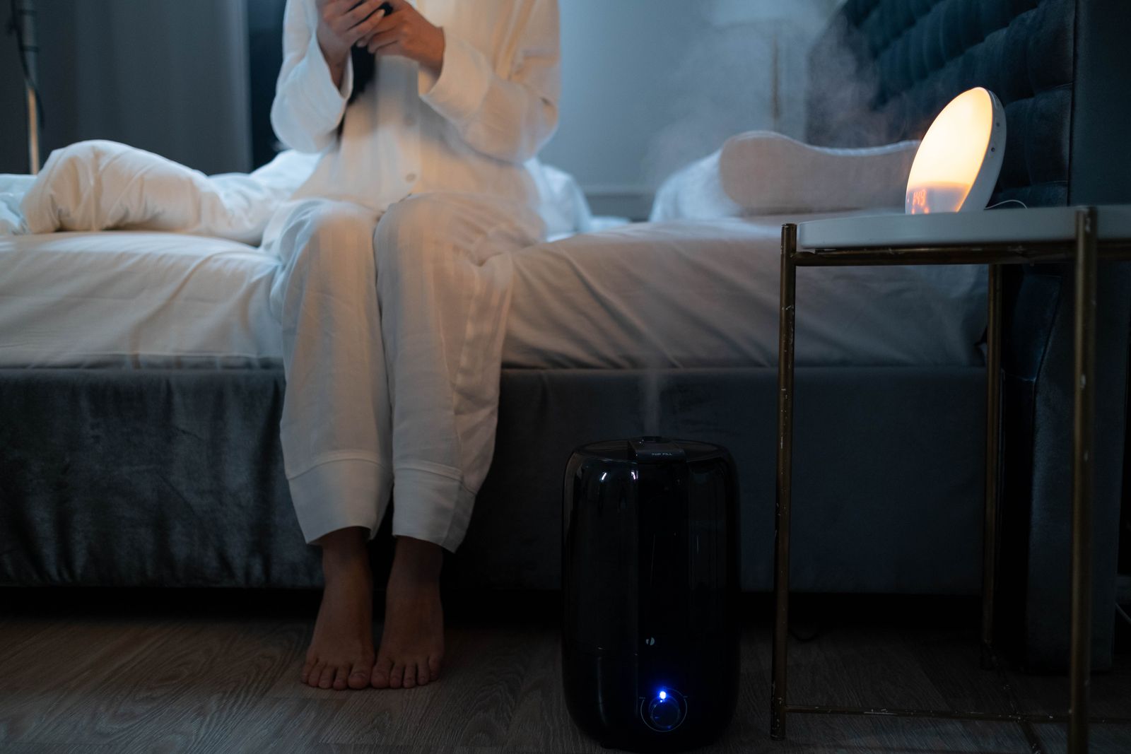 Modern white air purifier running in a bright living room