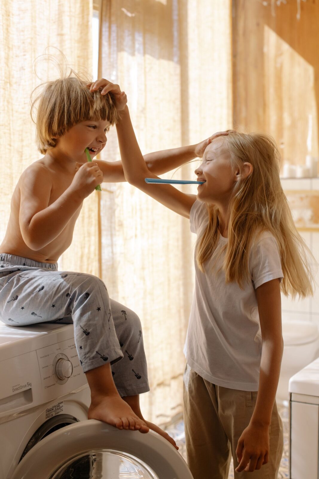 Two children brushing their teeth together