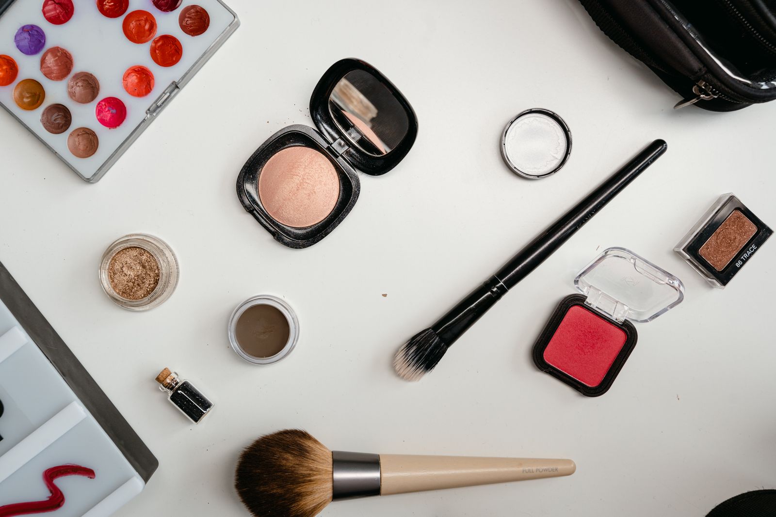 Makeup sponge, foundation brush, and foundation bottle lined up