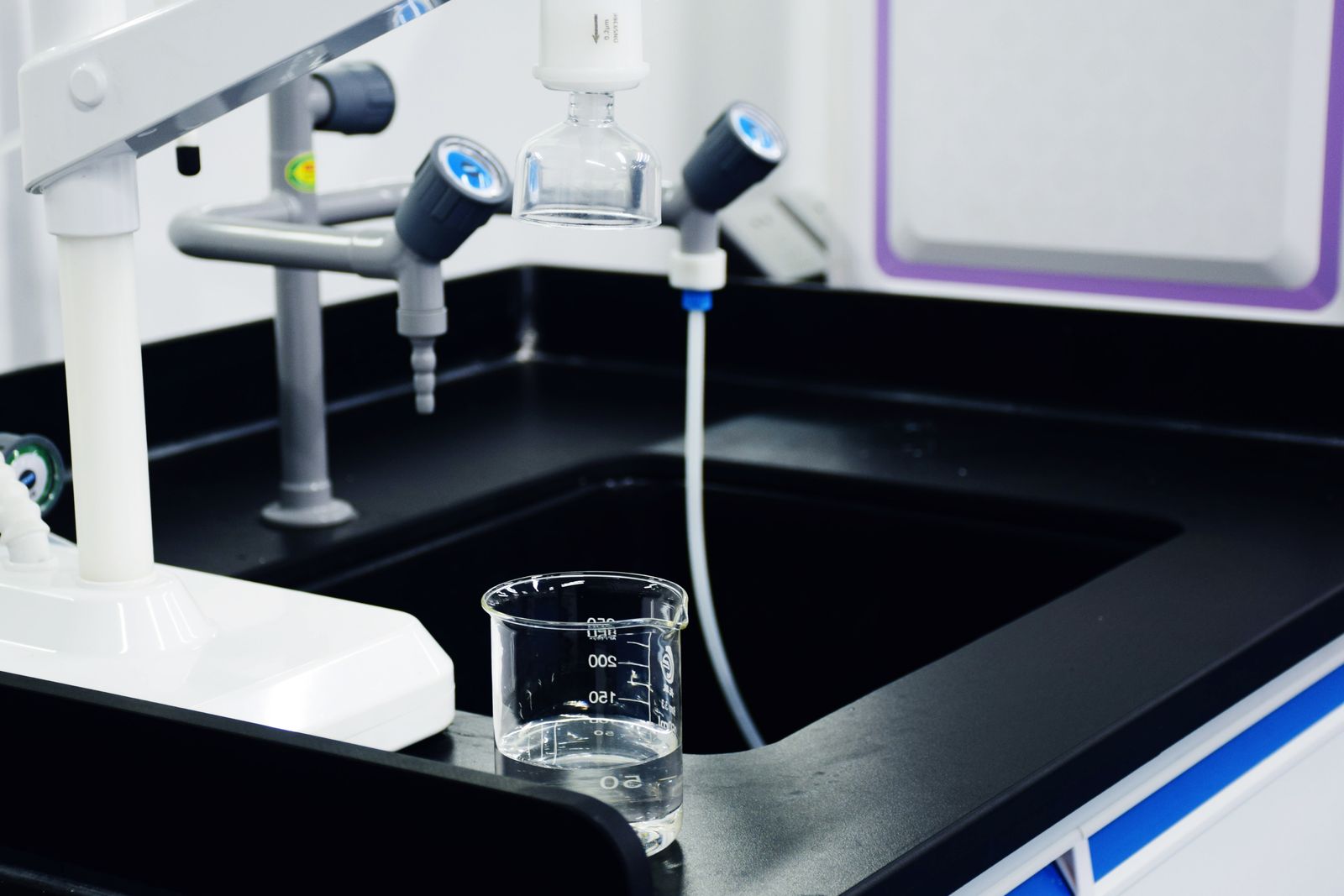 A digital water-quality meter in a glass of water
