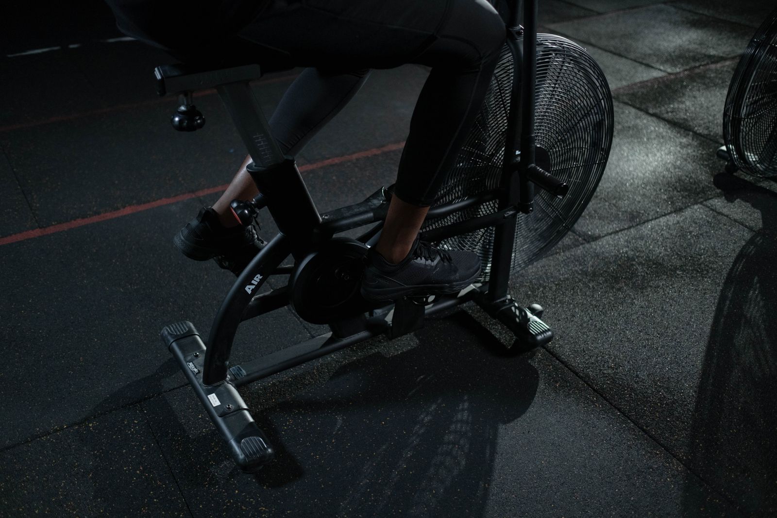 Person using a stationary exercise bike indoors