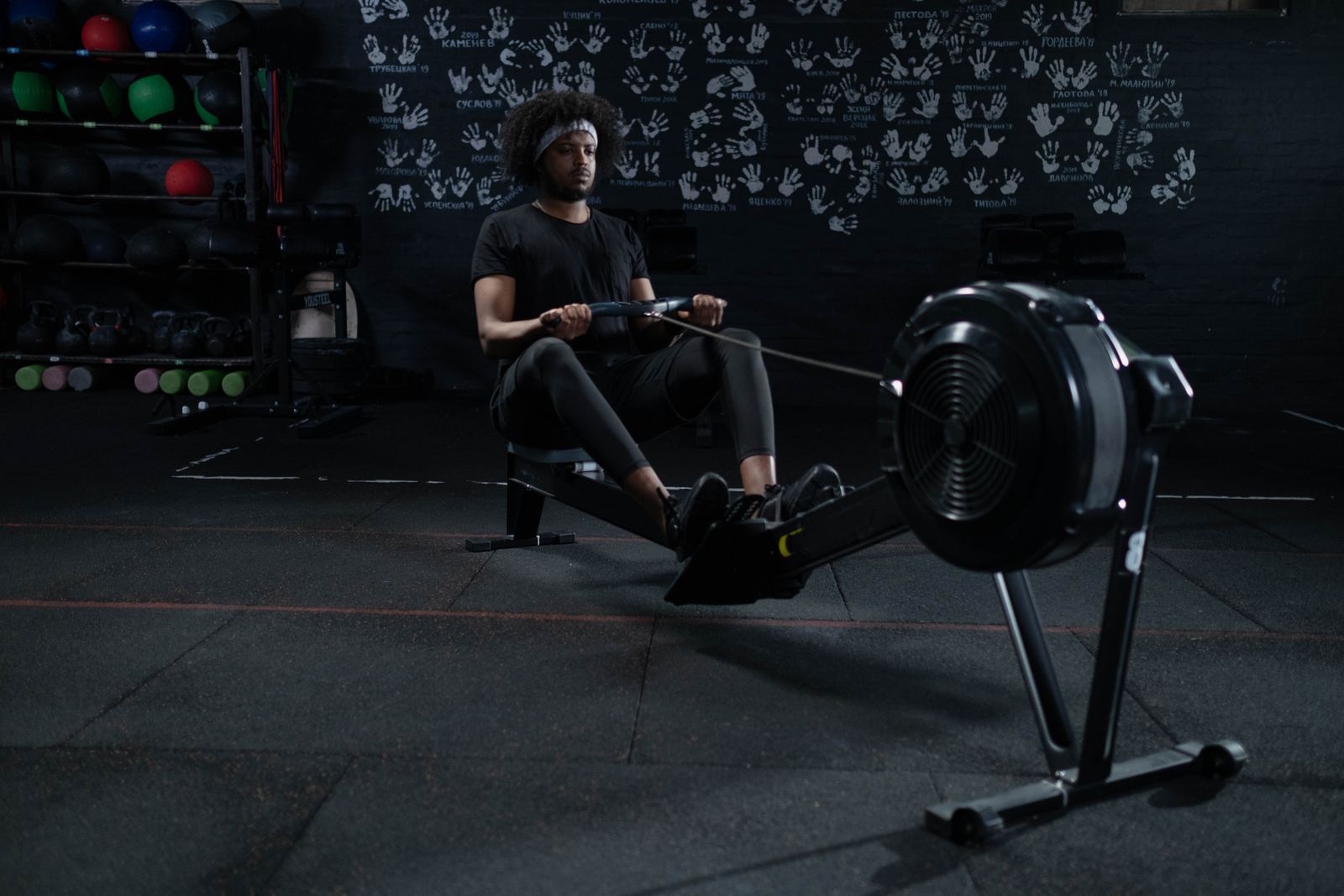 Person using an indoor rowing machine in a home gym