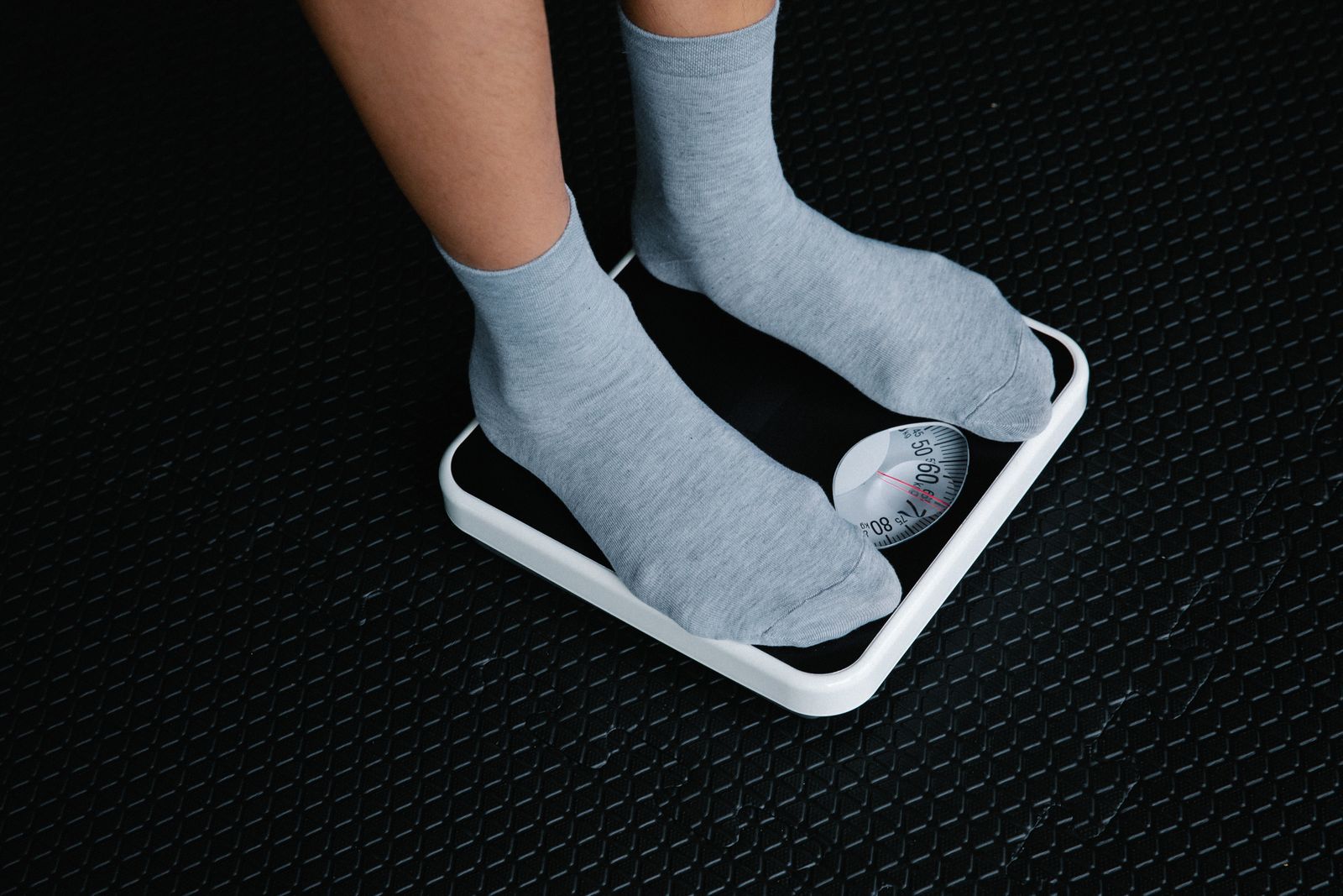 Feet stepping onto a minimalist smart scale