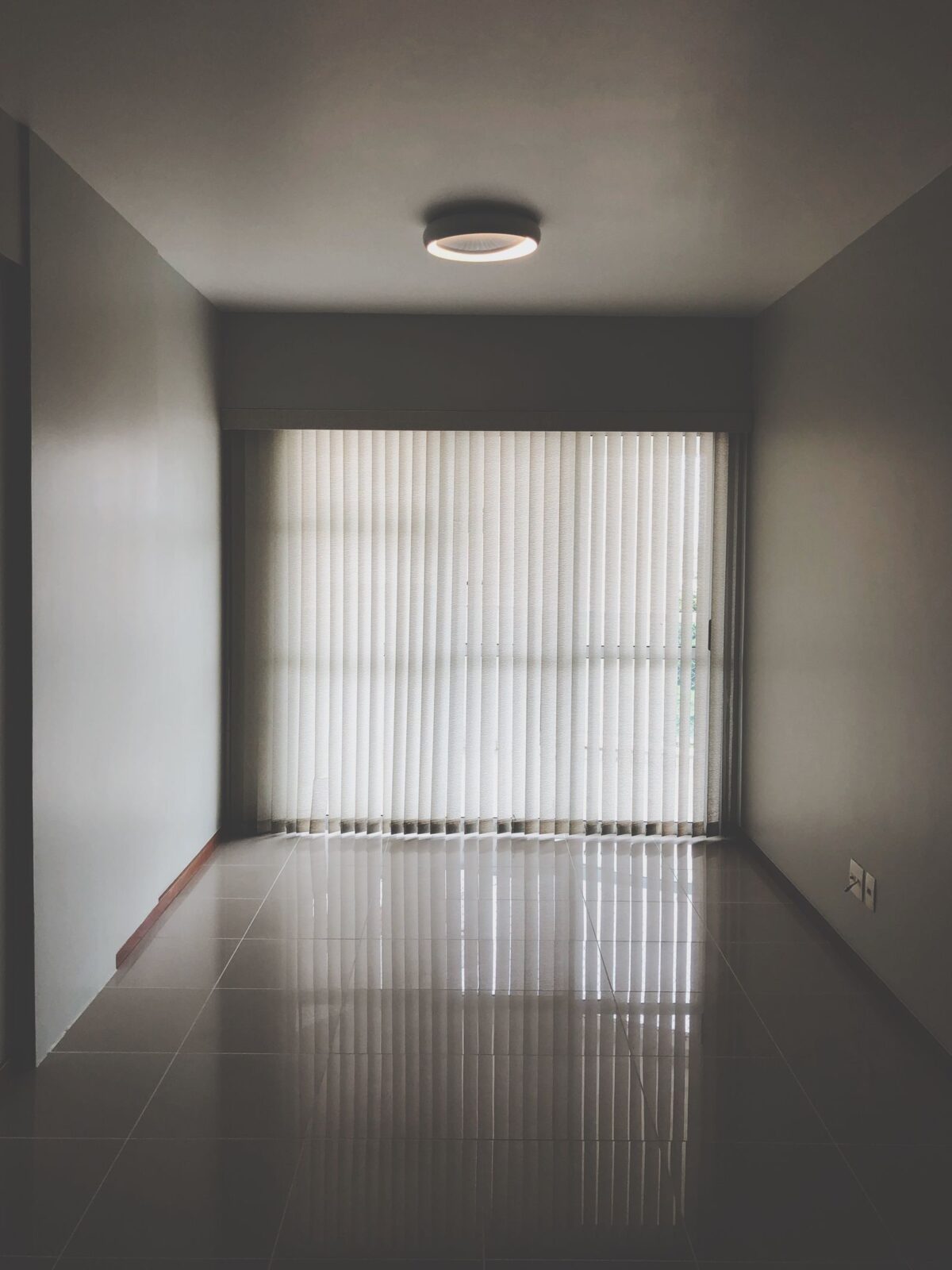Cozy bedroom with floor-to-ceiling blackout curtains drawn shut